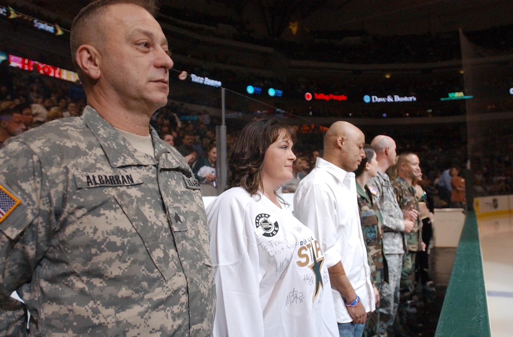 RANDOLPH AIR FORCE BASE, Texas - Sergeant Kenneth Albarran (left), a war veteran undergoing treatment at Brooke Army Medical Center, and several other San Antonio military members and veterans stand as they are recognized in between periods at a Dallas Stars hockey home game Feb. 23. (U.S. Air Force photo by Staff Sgt. Beth Del Vecchio)                               