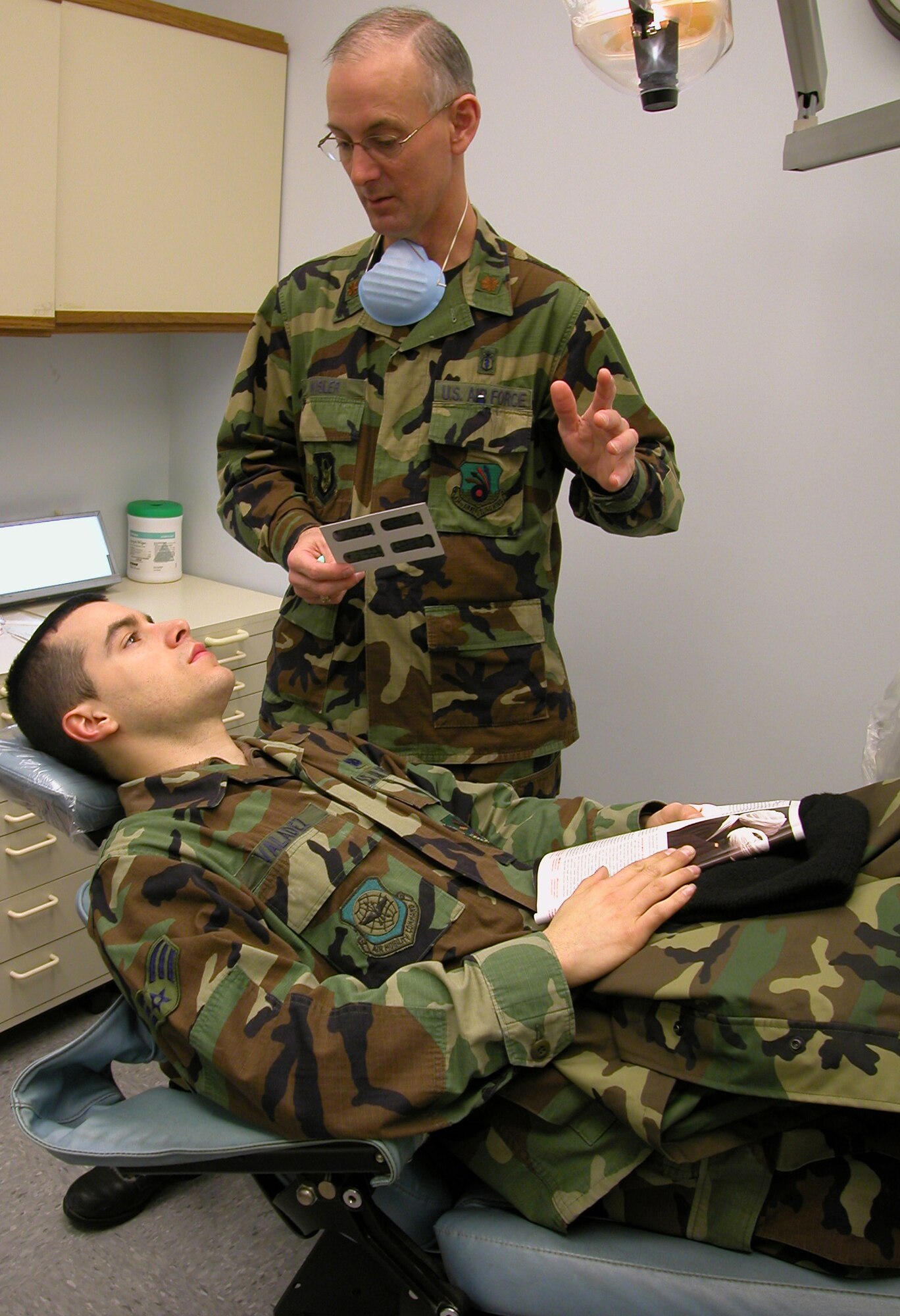 GRISSOM AIR RESERVE BASE, Ind., -- Maj. (Dr.) Craig Wisler, a dentist with the 434th Aerospace Medicine Squadron, discusses the information seen in the dental x-rays of SrA. Martin Valadez.  Airman Valadez is an aircraft electrical and environmental systems apprentice.  He is undergoing an annual dental exam required by the department of defense. (Air Force photo / SrA. Ben Mota)