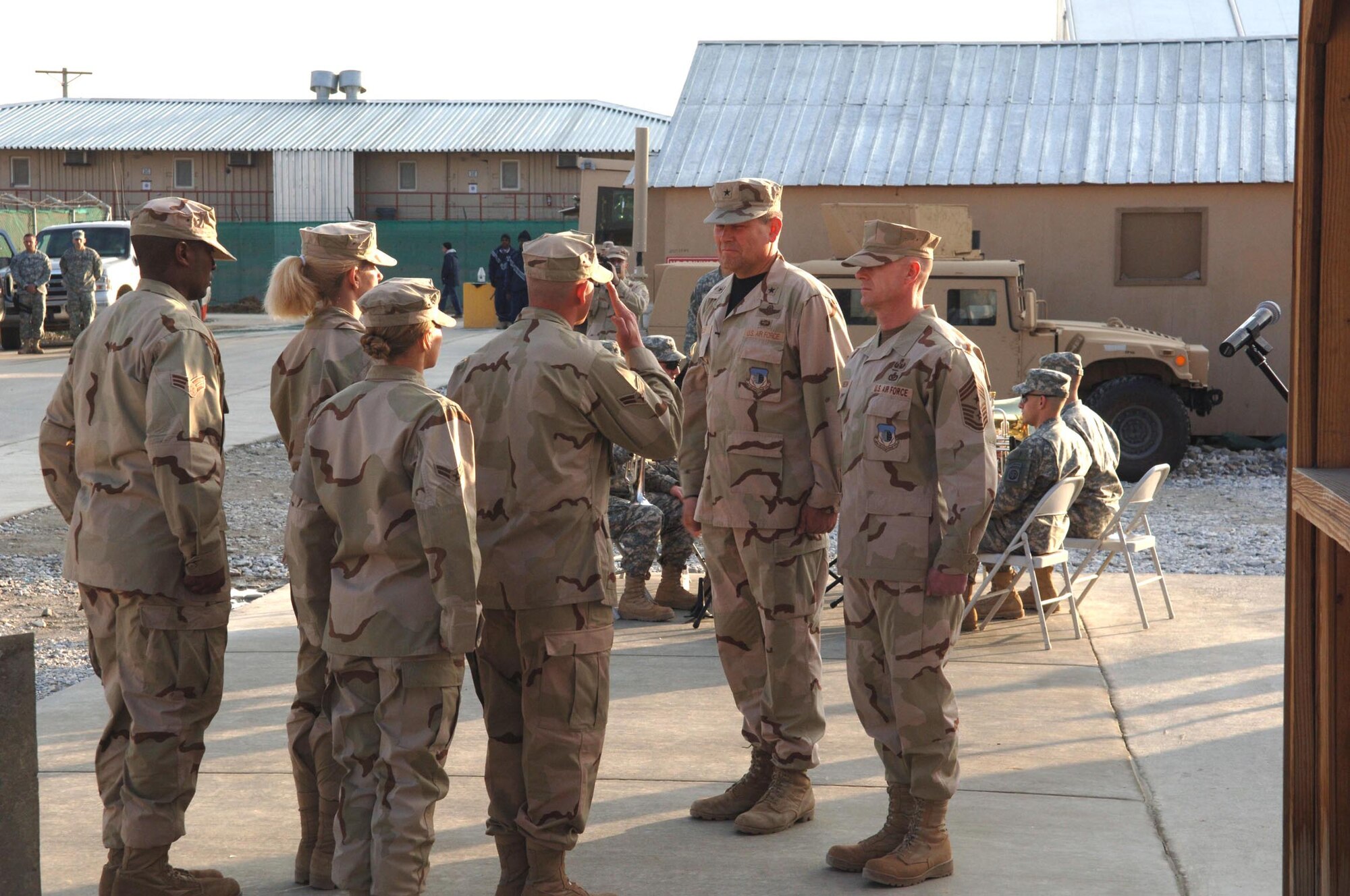 An honor guard presents the American flag to Brig. Gen. Christopher Miller, 455th Air Expeditionary Wing commander, and Chief Master Sgt. David Williamson, 455th AEW command chief master sergeant, during the retreat ceremony. The cermony honored twenty Airmen who have died in Afghanistan since 2001. (U.S. Air Force photo/Capt. Travis B. Tougaw)