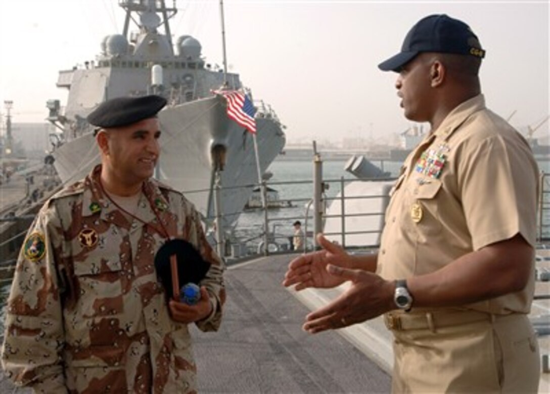 USS Anzio (CG 68) Command Master Chief William Seegars talks to Iraqi navy Chief Warrant Officer 2nd Class Abdul Majeed during a tour of the ship in Bahrain, Feb. 26, 2007. Majeed, the senior noncommissioned officer of the Iraqi navy's surface component, toured Anzio and USS Whirlwind (PC 11) with Commander, U.S. Naval Forces Central Command/U.S. 5th Fleet Command Master Chief Kelly Schneider. 
