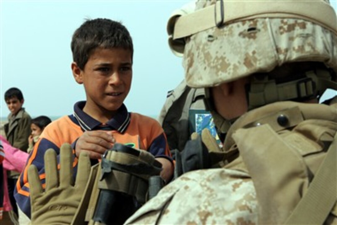 U.S. Army Sgt. Joseph S. Singleton plays with an Iraqi boy Feb. 23, 2007. Al Angur, a town that American forces started patrolling in October 2006, has opened its arms to the coalition forces that now patrol its streets. Soldiers from the 1st Iraqi Army Division patrolled alongside the U.S. soldiers and Marines. 