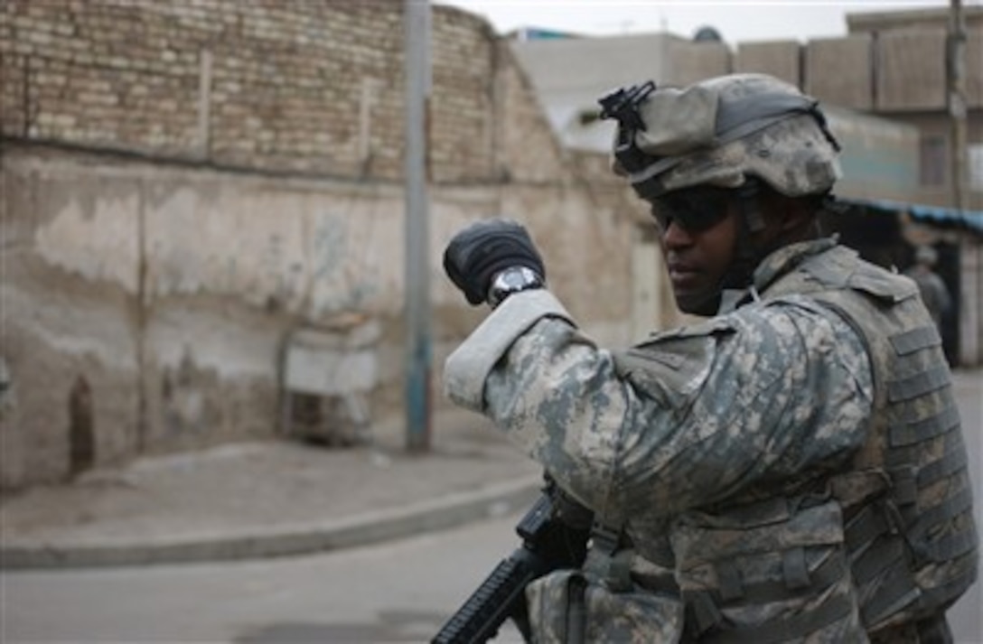 U.S. Army Spc. Terry Patton gives the command to halt during a presence patrol in Al Salaam, Iraq, on March 1, 2007.  Patton is assigned to Bravo Company, 1st Battalion, 325th Airborne Infantry Regiment, 2nd Brigade Combat Team, 82nd Airborne Division.  