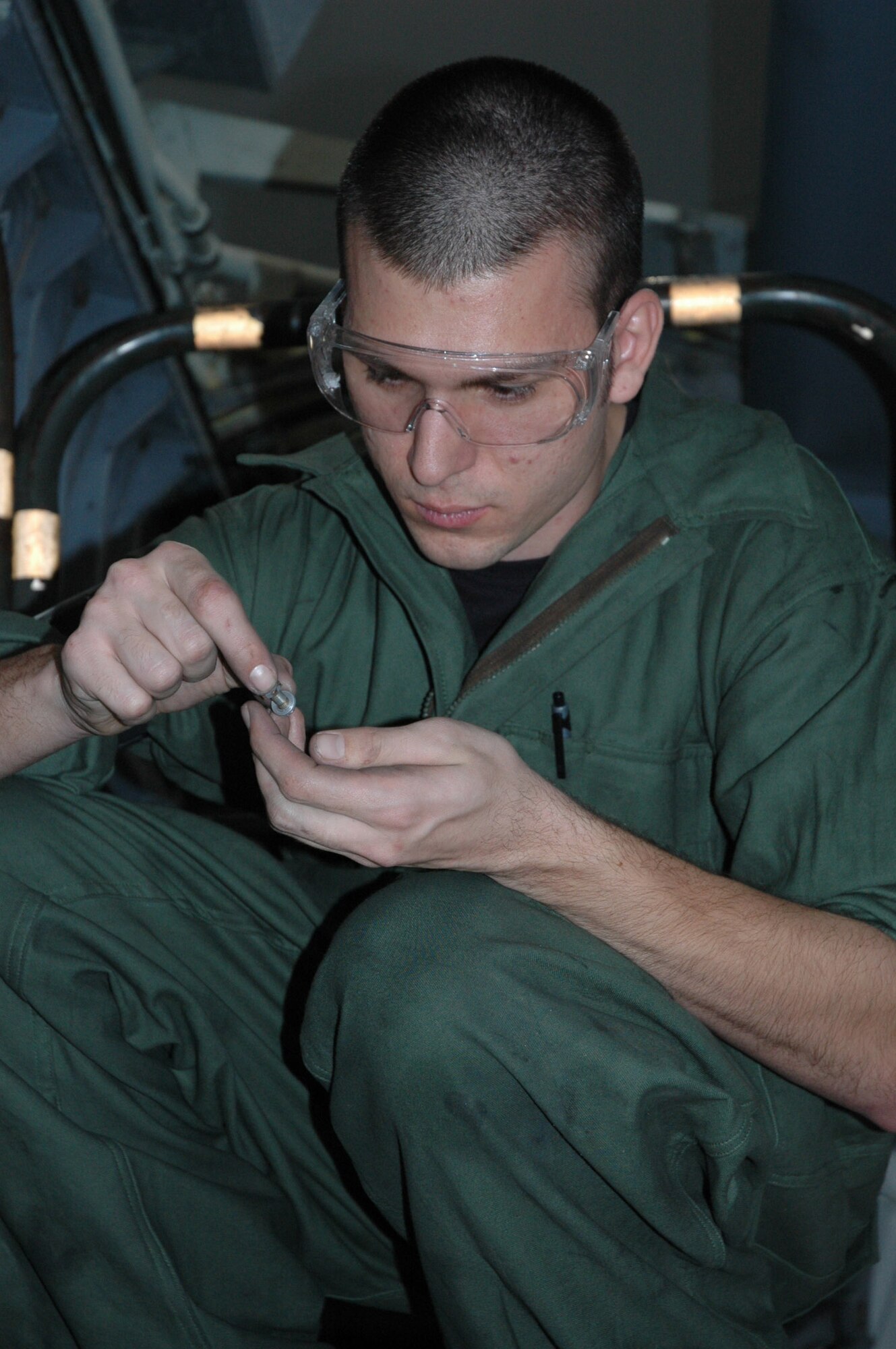 Airman 1st Class Jamie Wellbrock counts bolts in the ISO dock during a media visit from Peter Spiegel, a reporter from the Los Angeles Times newspaper, March 6 at McConnell Air Force Base.  Mr. Spiegel spent a day visiting with Team McConnell members, learning about the KC-135 Refueler. (Air Force Photo by Tech. Sgt. Genevieve Morris 22nd ARW Public Affairs office)