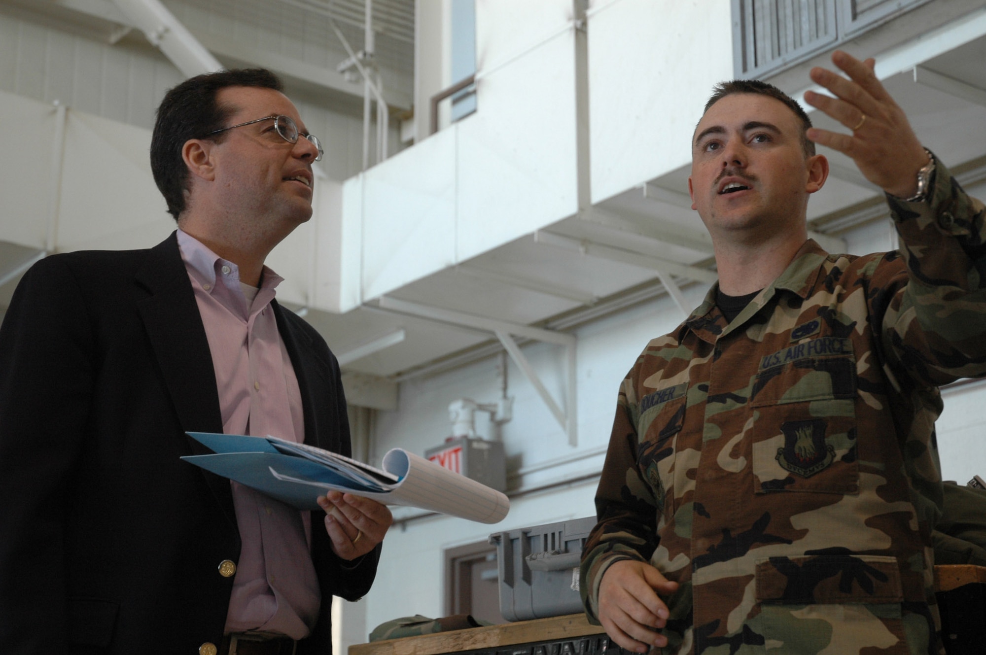 Staff Sgt. Phillip Boucher, 22nd Maintenance Squadron, discusses fuel cell maintenance with Peter Spiegel, a reporter from the Los Angeles Times newspaper, March 6 at McConnell Air Force Base.  Mr. Spiegel spent a day visiting with Team McConnell members, learning about the KC-135 Refueler. (Air Force Photo by Tech. Sgt. Genevieve Morris 22nd ARW Public Affairs office)