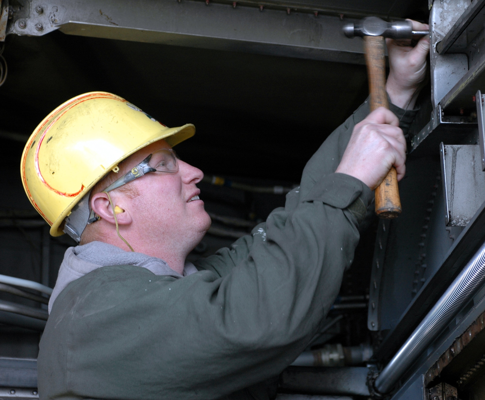 Mr. Jeremiah McNamara, 60th Equipment Maintenance Squadron Air Reserve technician, removes a rivot from a wing flap section of a C-5 Globemaster III. This task is part of the Isochronal inspection performed every 420 days on the aircraft.  The 60th EMS recently won the 2006 Air Mobility Command’s Maintenance Effectiveness Award. (U.S. Air Force photo by Tech. Sgt. Donald Osborn)