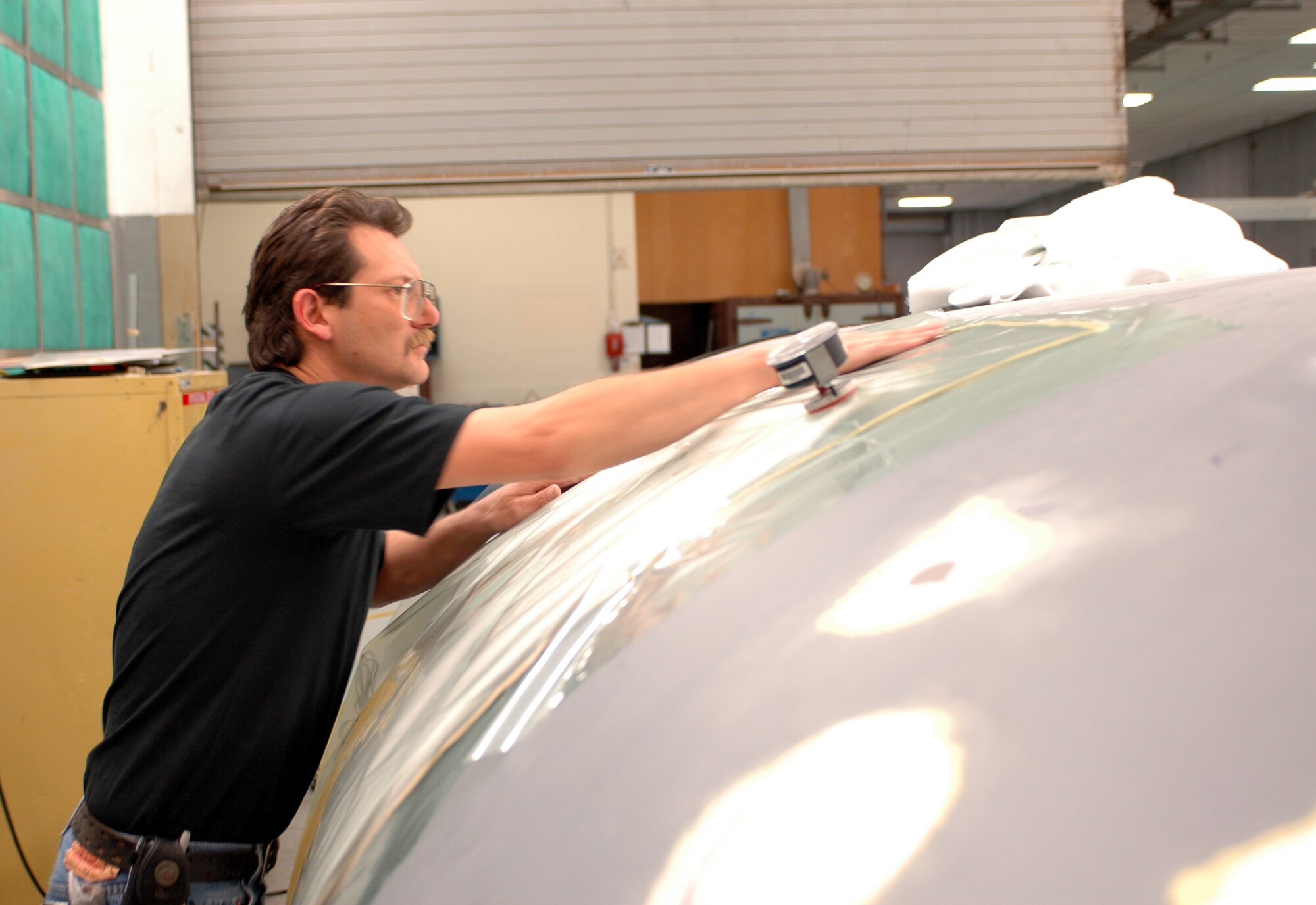 Mr. Rhett Sootoo, 60th Equipment Maintenance Squadron plastics worker, “bags a repair” on a wing section from a C-5 Globemaster III. “Bagging a repair” creates a vacuum that equalizes pressure throughout the repaired section. (U.S. Air Force photo by Tech. Sgt. Donald Osborn)