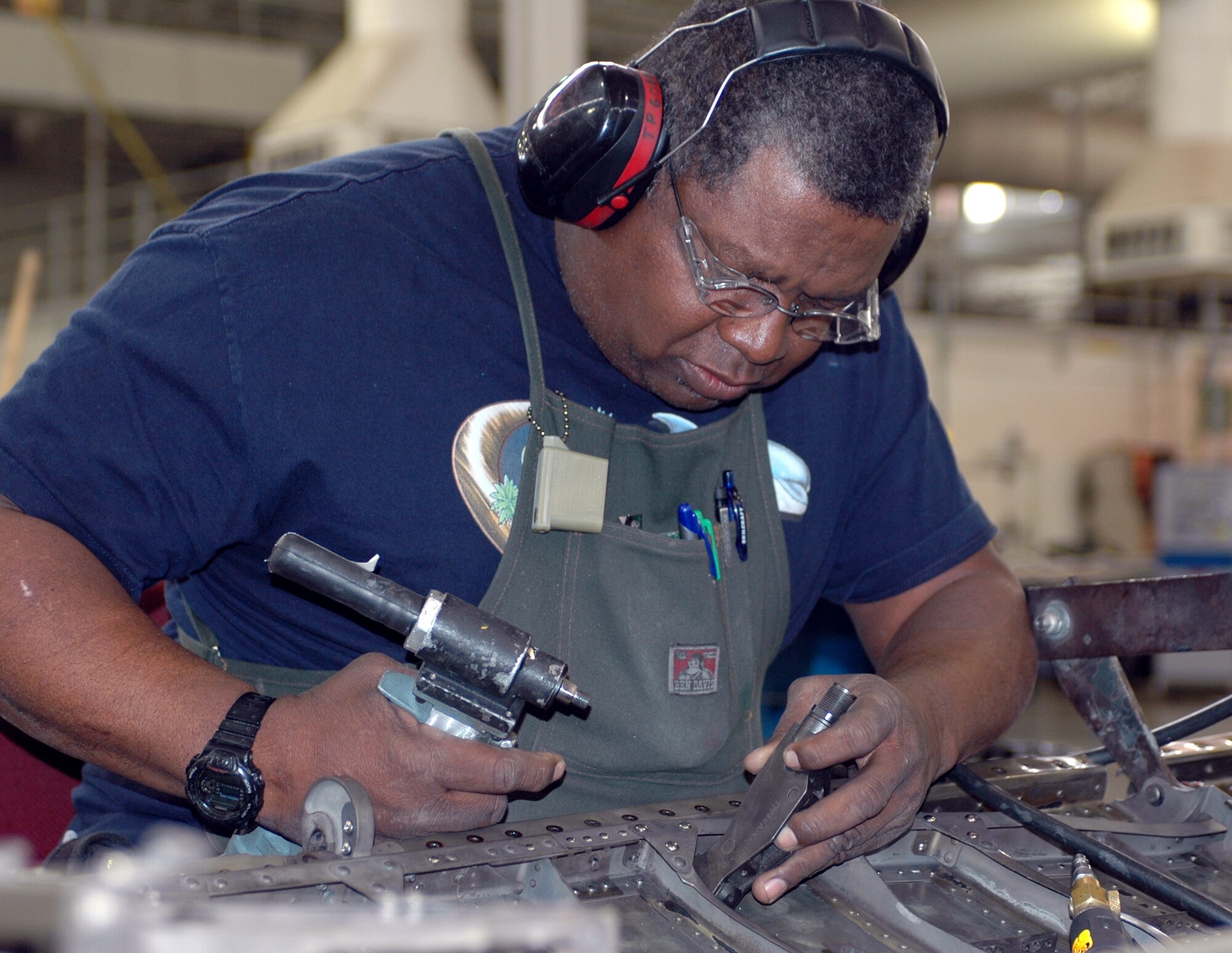 Mr. John Waddles, 60th Equipment Maintenance Squadron structure repair technician, refurbishes a C-5 engine pylon apron. The 60th EMS saved more than $48 million in 2006 by refurbishing and manufacturing parts for Travis’ aircraft. The 60th EMS recently won the 2006 Air Mobility Command’s Maintenance Effectiveness Award. (U.S. Air Force photo by Tech. Sgt. Donald Osborn)