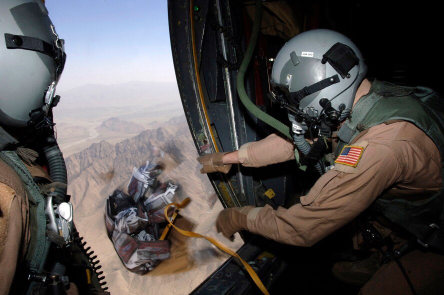 Airman 1st Class Josh Huffman, a C-130 Hercules loadmaster deployed from Dyess' 40th Airlift Squadron, drops a box of 10,000 warning leaflets over the southeastern mountains of Afghanistan March 6. The leaflets were used to communicate with Taliban extremists, warning them not to interfere with coalition activities. The leaflet airdrop mission is contributing to Operation Achilles, launched by the International Security Assistance Force to create an environment that will enable the government of Afghanistan to help improve security and the quality of life for Afghan people. (U.S. Air Force photo/Tech. Sgt. Cecilio Ricardo) 
