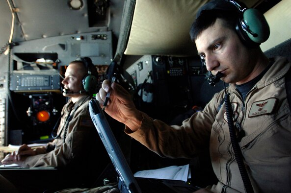 Maj. Jaska Cason, a C-130 Hercules mission commander, calculates coordinates and prepares his crew to drop 30,000 warning leaflets over the southeastern mountains of Afghanistan.  The March 6 leaflet airdrop mission is contributing to Operation Achilles, launched by the International Security Assistance Force to create an environment that will enable the government of Afghanistan to help improve security and the quality of life for Afghan people. (U.S. Air Force photo/Tech. Sgt. Cecilio Ricardo)