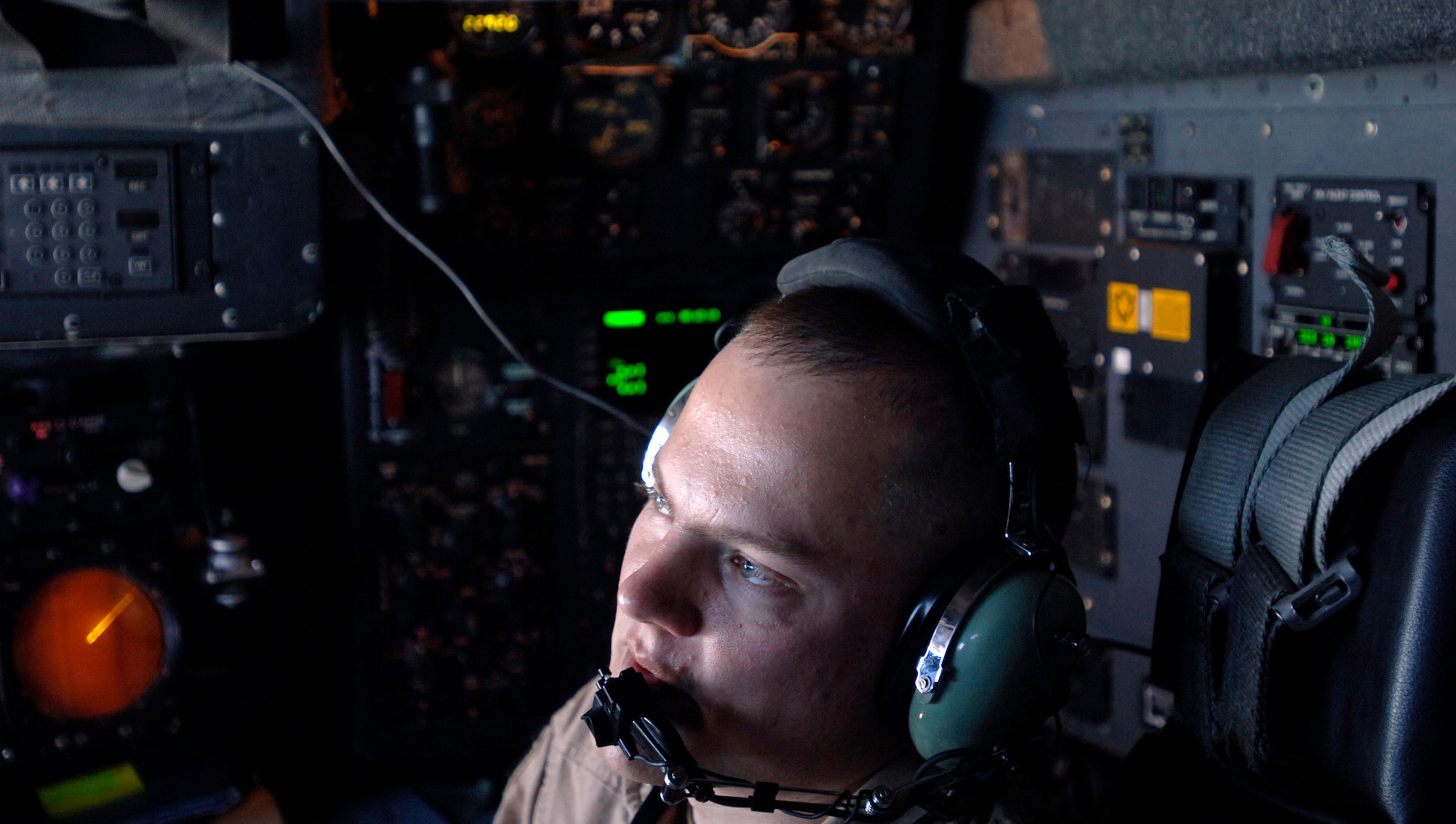 Captain Tim Romin, a C-130 Hercules aircraft navigator, coordinates mission maneuvers with his crew March 6 before dropping 30,000 warning leaflets over the southeastern mountains of Afghanistan. The leaflet airdrop mission is contributing to Operation Achilles launched by International Security Assistance Force to help improve security and the Afghan people's quality of life. (U.S. Air Force photo/Tech. Sgt. Cecilio Ricardo) 
