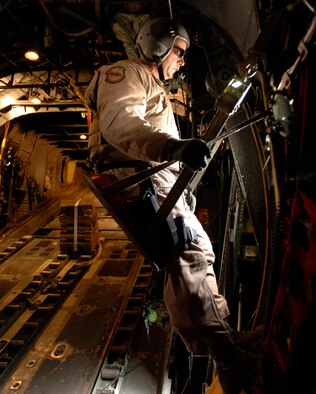 Master Sgt. Jim Read, a C-130 Hercules loadmaster, scans the terrain for enemy activity March 6 while he and his crew prepare to drop 30,000 warning leaflets over the southeastern mountains of Afghanistan. The leaflet airdrop mission is contributing to Operation Achilles launched by International Security Assistance Force to help improve security and the Afghan people's quality of life. (U.S. Air Force photo/Tech. Sgt. Cecilio Ricardo) 