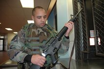 MINOT AIR FORCE BASE, N.D. – Tech. Sgt. Crumel Mooring, Minot Air Force Base Military Equal Opportunity office, checks out an M-16 at the base armory. Sergeant Mooring was recently named the 2006 Air Combat Command Security Forces NCO Augmentee of the Year. (U.S. Air Force photo by Senior Airman Danny Monahan)