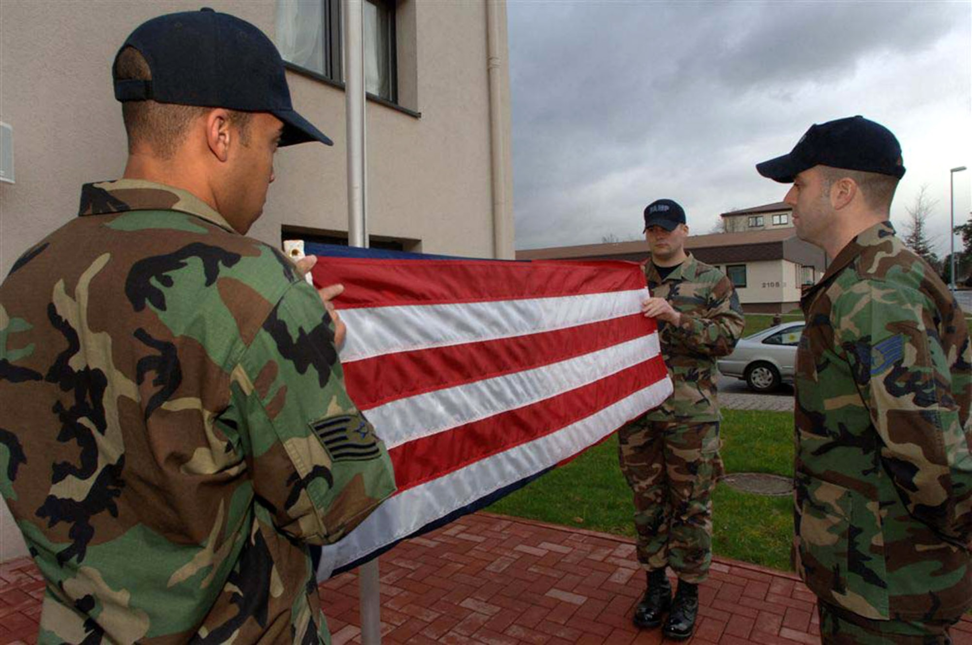 Staff Sgt. Joe Gallina (right) stands at parade rest as Ramstein Area Motivational Program, or RAMP, staff members retire the flag during a retreat ceremony.  Sergeant Gallina has been part of the RAMP cadre since September 2004. (U.S. Air Force photo/Airman 1st Class Julianne Showalter)