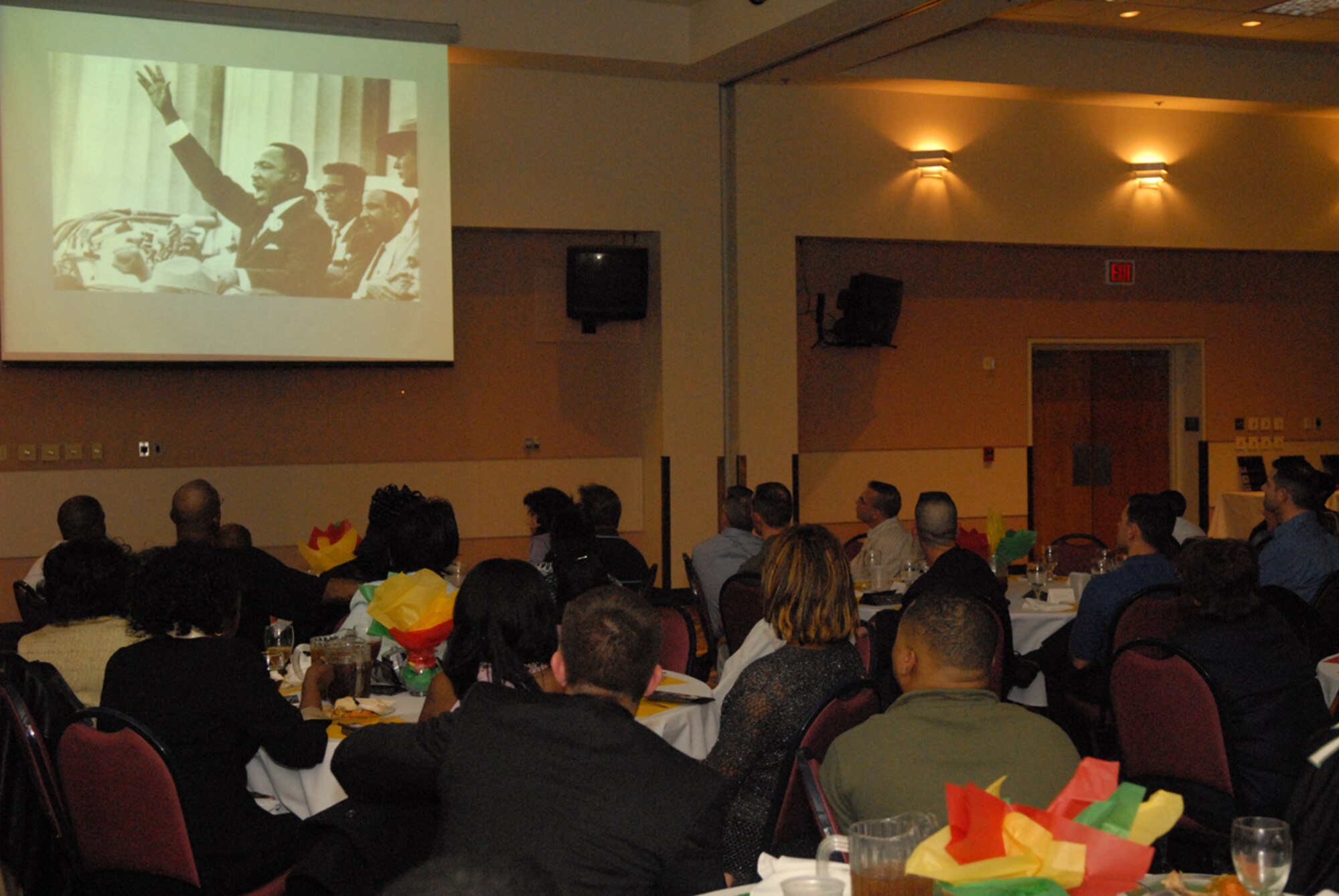 Guests watch a special slide presentation on Black history while Pastor Theodore Boone recites one of Dr. Martin Luther King Jr.’s speeches. “It was never boring. I enjjoyed the entertainment and I think the committee did an excellent job of educating guests about the contributions of African-Americans to American society. I really enjoyed the slide presntation too,” commented Airman 1st Class Stephanie Jackson. (U.S. Air Force photo by Tech Sgt. Randy Mallard)