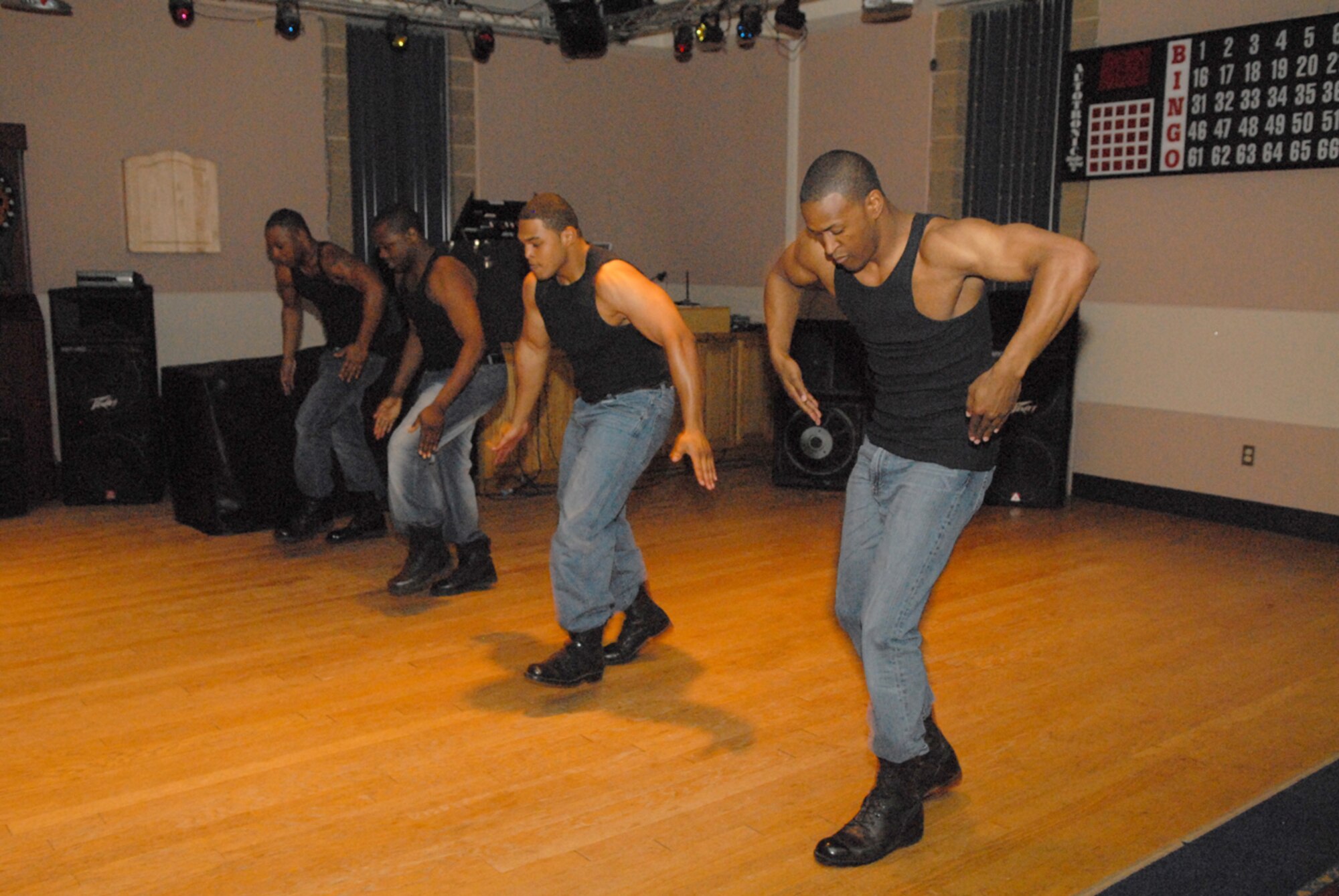 From left to right: Staff Sgt. Charmane Tatum, Airman 1st Class Mike Givan, 2nd Lt. James King and 2nd Lt. Brian Williams stomp the yard by demonstrating some step moves traditionally perfomed by African-American college fraternities and sororities as part of one of several dancing perfomances of the evening. (U.S. Air Force photo by Tech Sgt. Randy Mallard)