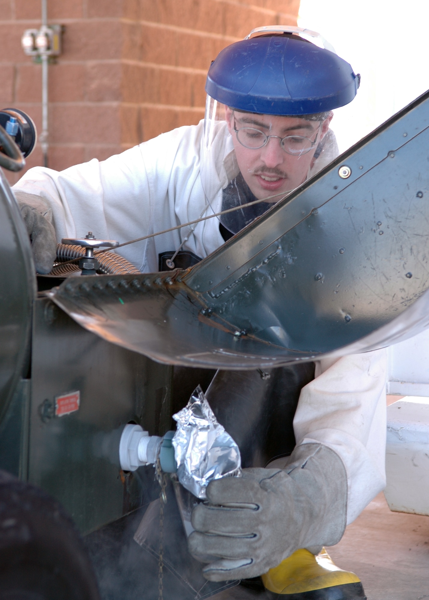 Senior Airman Steven Dessino, 49th Logistics Readiness Squadron, takes a sample of LOX (liquid oxygen) before checking for the proper amount of particulate odor. (U.S. Air Force photo by Airman Jamal Sutter)