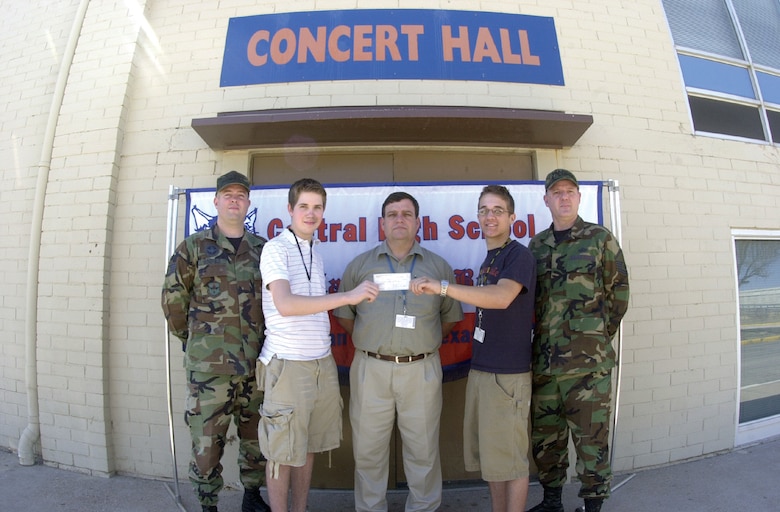 Staff Sgt. Jay Wingfield (left), NCO Association Ft. Concho Chapter president, and Master Sgt. Richard Jude (far right), Goodfellow Air Force Base 2007 Annual Awards Committee chair, stand with (center from left to right ) Central High School Sophomore Logan Mims, Keith Calls, CHS band director, and CHS senior Brian Melton outside the CHS Concert Hall Tuesday in San Angelo. The CHS students hold a $150 donation check from the NCO Association made to the CHS band for their jazz performance during the GAFB 2007 Annual Awards. CHS students Mims and Melton were two of the four students who played at the event. CHS seniors Matt Dane and Jerome Ibarra were not available for the photo. (U.S. Air Force photo by Airman 1st Class Luis Loza Gutierrez)