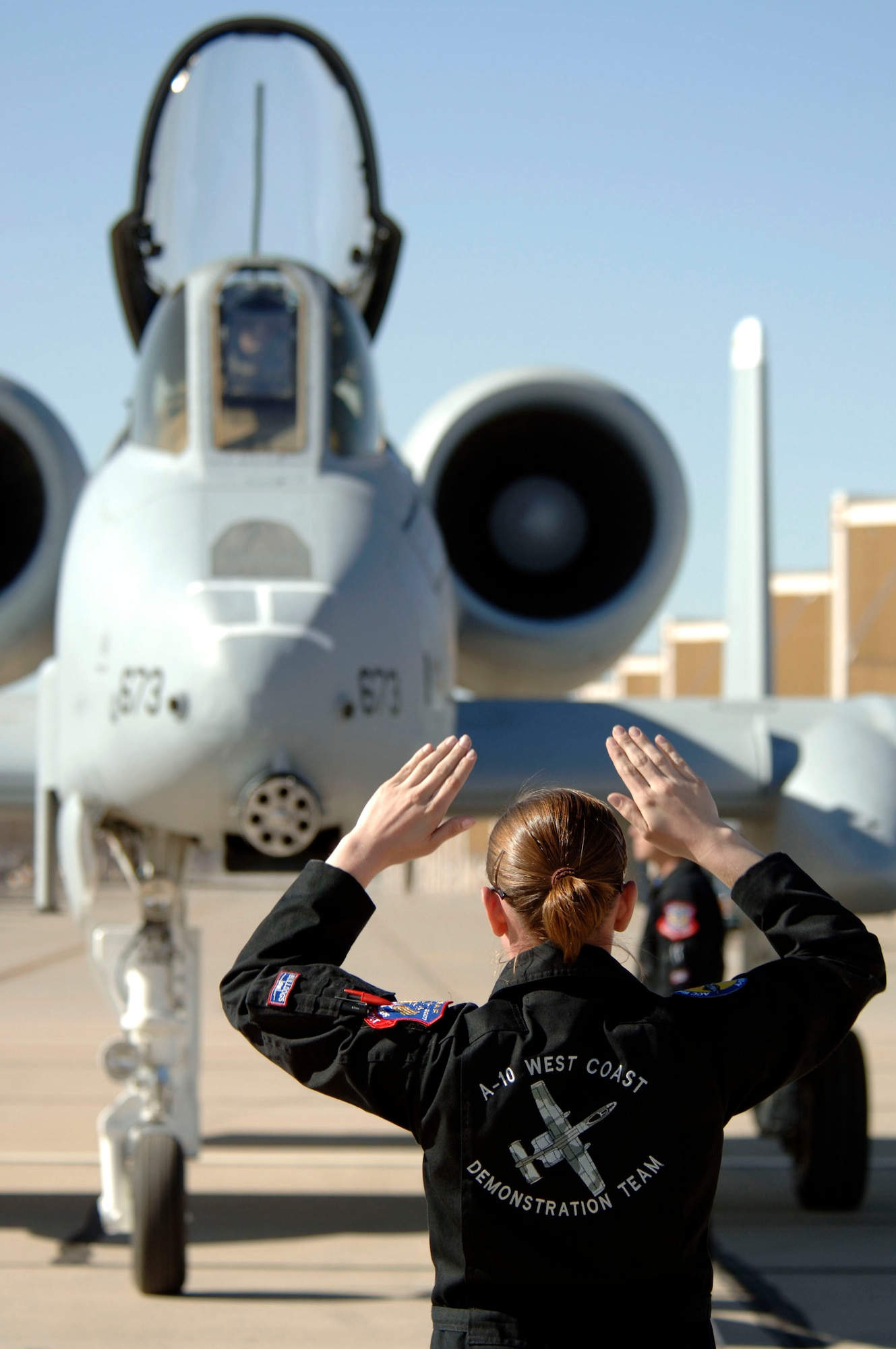 Staff Sgt. Jennifer Eriksen marshals an A-10 Thunderbolt II after an aerial demonstration flight March 3 at the 2007 Heritage Conference at Davis-Monthan Air Force Base, Ariz.  The conference provides an opportunity for ACC demonstration pilots to train together with modern and historic military aircraft in preparation for the upcoming air-show season.  The West Coast team is assigned to the 355th Wing at Davis-Monthan AFB.  (U.S. Air Force photo/Senior Airman Christina D. Ponte)