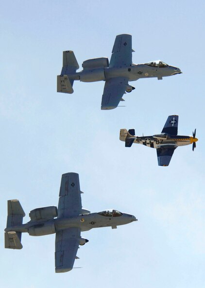 Two A-10 Thunderbolt IIs flank a P-51 Mustang to demonstrate aerial capabilities March 3 during the 2007 Heritage Conference at Davis-Monthan Air Force Base, Ariz.  The conference provides an opportunity for ACC demonstration pilots to train together with modern and historic military aircraft in preparation for the upcoming air-show season.   (U.S. Air Force photo/Senior Airman Christina D. Ponte)