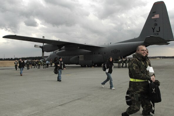 YOKOTA AIR BASE, Japan -- Volunteers from Kunsan Air Base, Korea, offload from a C-130 Hurcules from the 36th Airlift Squadron as part of a Noncombatant Evacuation Operation exercise. The NEO exercise was part of an overall Initial Response Readiness Inspection conducted by the Pacific Air Forces Inspector General to test the 374th Airlift Wing's ability to respond to contingencies throughout the Pacific region. (U.S. Air Force photo by Master Sgt. Dominique Brown)