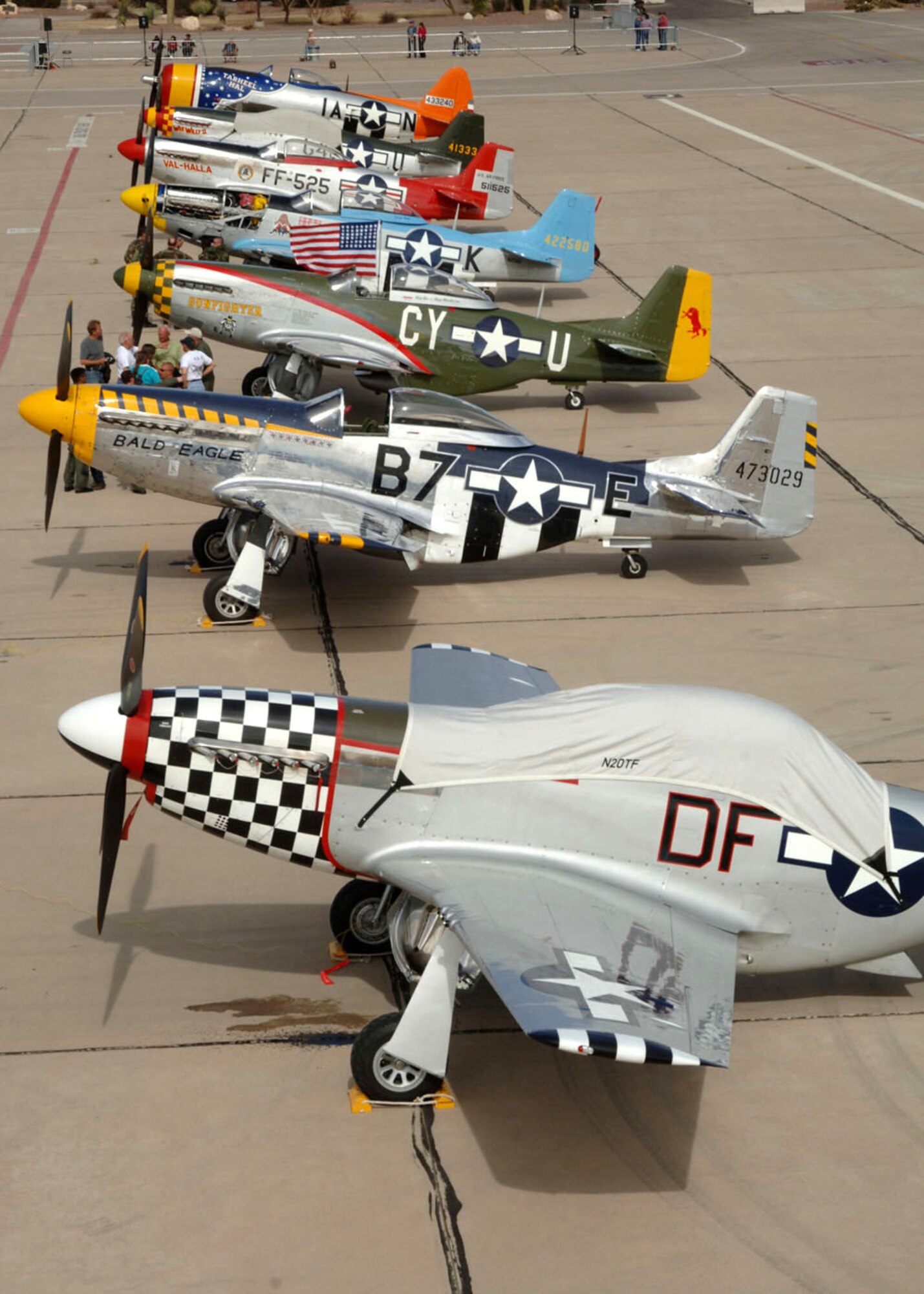 Pilots, crewmembers and spectators gather around several P-51 Mustangs and a P-47 Thunderbolt (rear) March 4 after a busy few days at the 2007 Heritage Conference at Davis-Monthan Air Force Base, Ariz.  The conference provided an opportunity for Air Combat Command demonstration pilots to train together with modern and historic military aircraft in preparation for the upcoming air-show season.  (U.S. Air Force photo/Staff Sgt. Lanie McNeal)