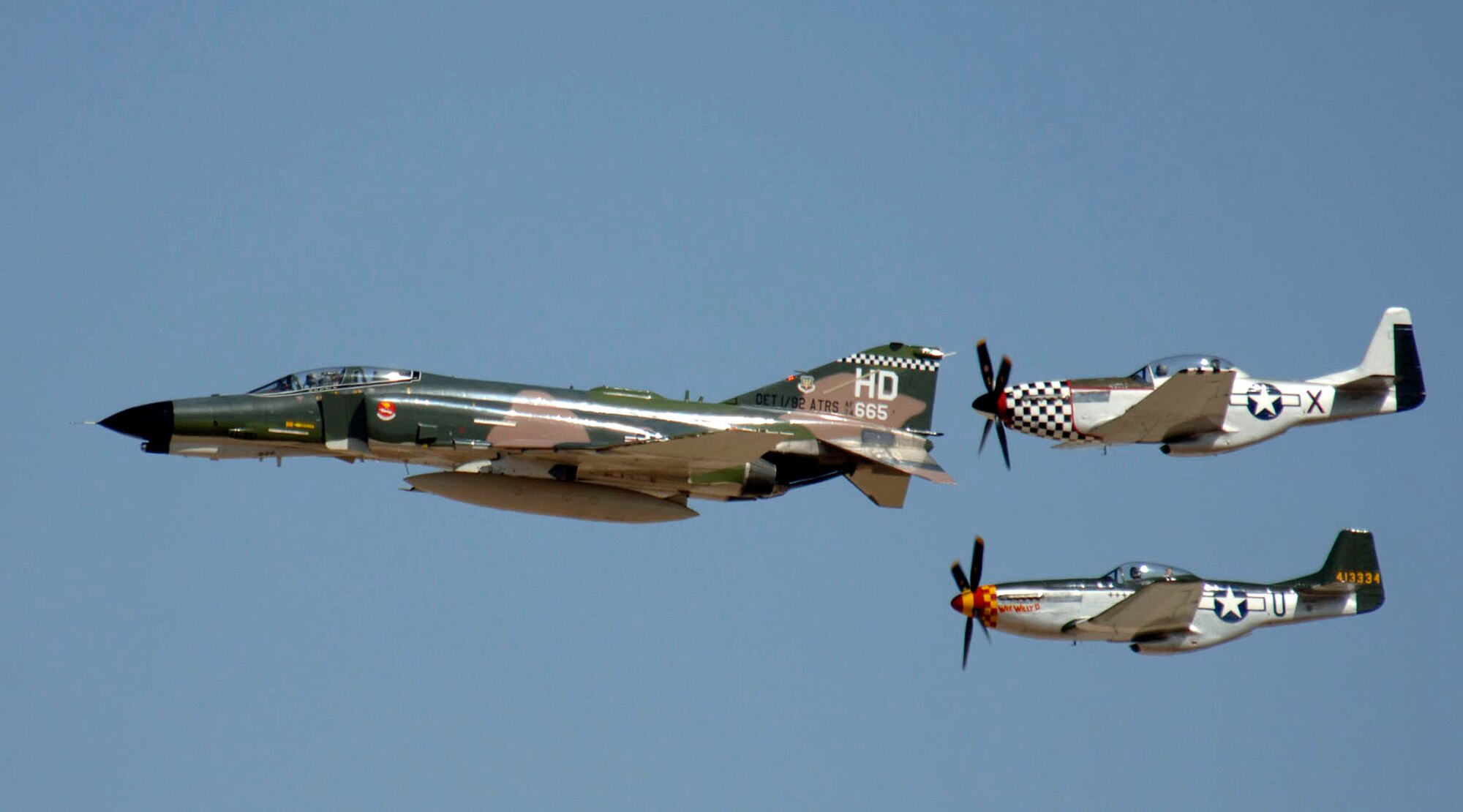 An F-4 Phantom II and two P-51 Mustangs demonstrate aerial capabilities March 3 during the 2007 Heritage Conference at Davis-Monthan Air Force Base, Ariz. The conference provides an opportunity for Air Combat Command demonstration pilots to train together with modern and historic military aircraft in preparation for the upcoming air-show season.  (U.S. Air Force photo/Senior Airman Christina D. Ponte)