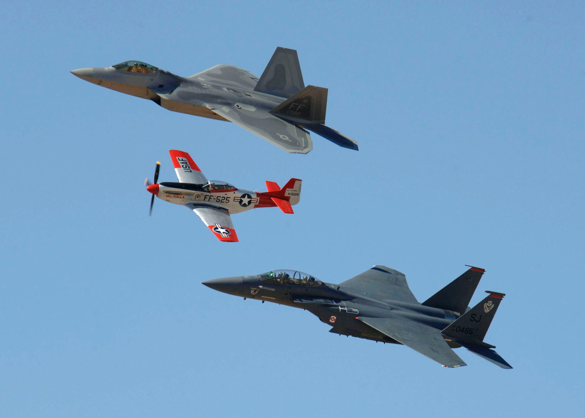 An F-22 Raptor, a P-51 Mustang and an F-15E Strike Eagle fly in formation March 3 during the 2007 Heritage Conference at Davis-Monthan Air Force Base, Ariz. The conference provides an opportunity for Air Combat Command demonstration pilots to train together with modern and historic military aircraft in preparation for the upcoming air-show season.  (U.S. Air Force photo/Senior Airman Christina D. Ponte)