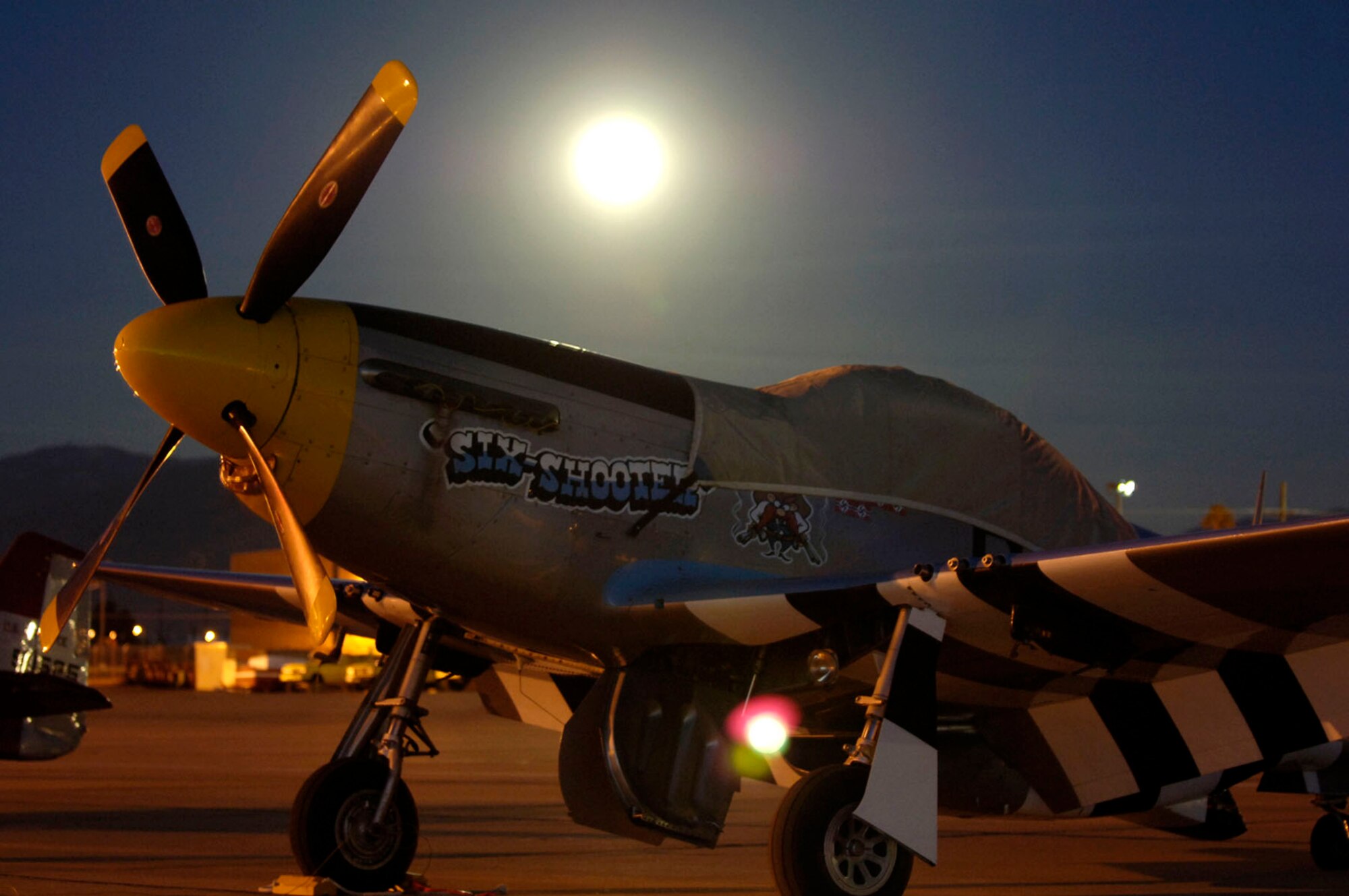 A P-51 Mustang spends the night on the flight line at David-Monthan Air Force Base, Ariz., March 3 during the 2007 Heritage Conference.  The conference provides an opportunity for Air Combat Command demonstration pilots to train together with modern and historic military aircraft in preparation for the upcoming air-show season.  (U.S. Air Force photo/Senior Airman Jesse Shipps)