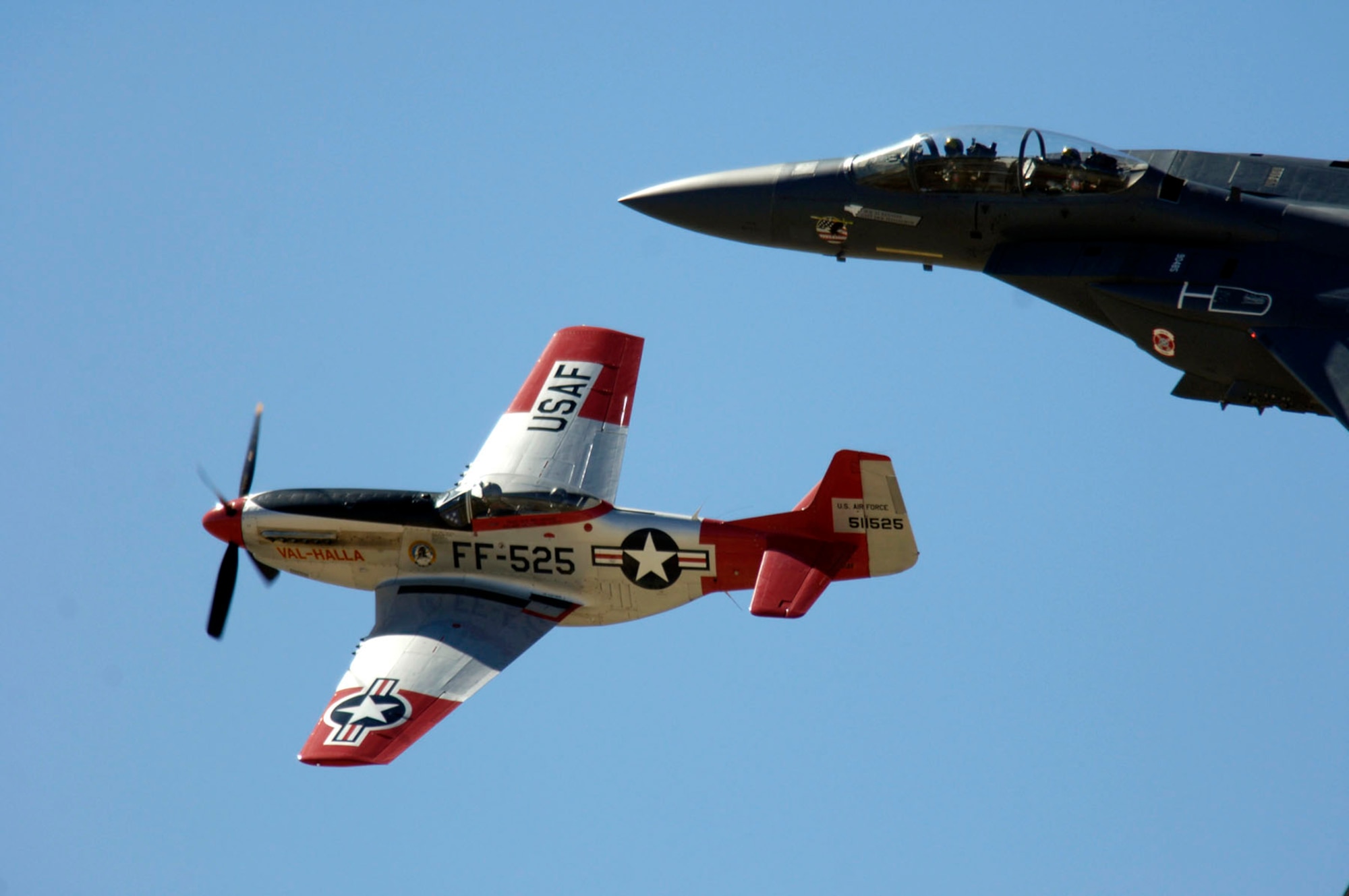 A P-51 Mustang and an F-15E Strike Eagle fly in formation March 3 during the 2007 Heritage Conference at Davis-Monthan Air Force Base, Ariz.  The conference provides an opportunity for Air Combat Command demonstration pilots to train together with modern and historic military aircraft in preparation for the upcoming air-show season.  (U.S. Air Force photo/Senior Airman Jesse Shipps)