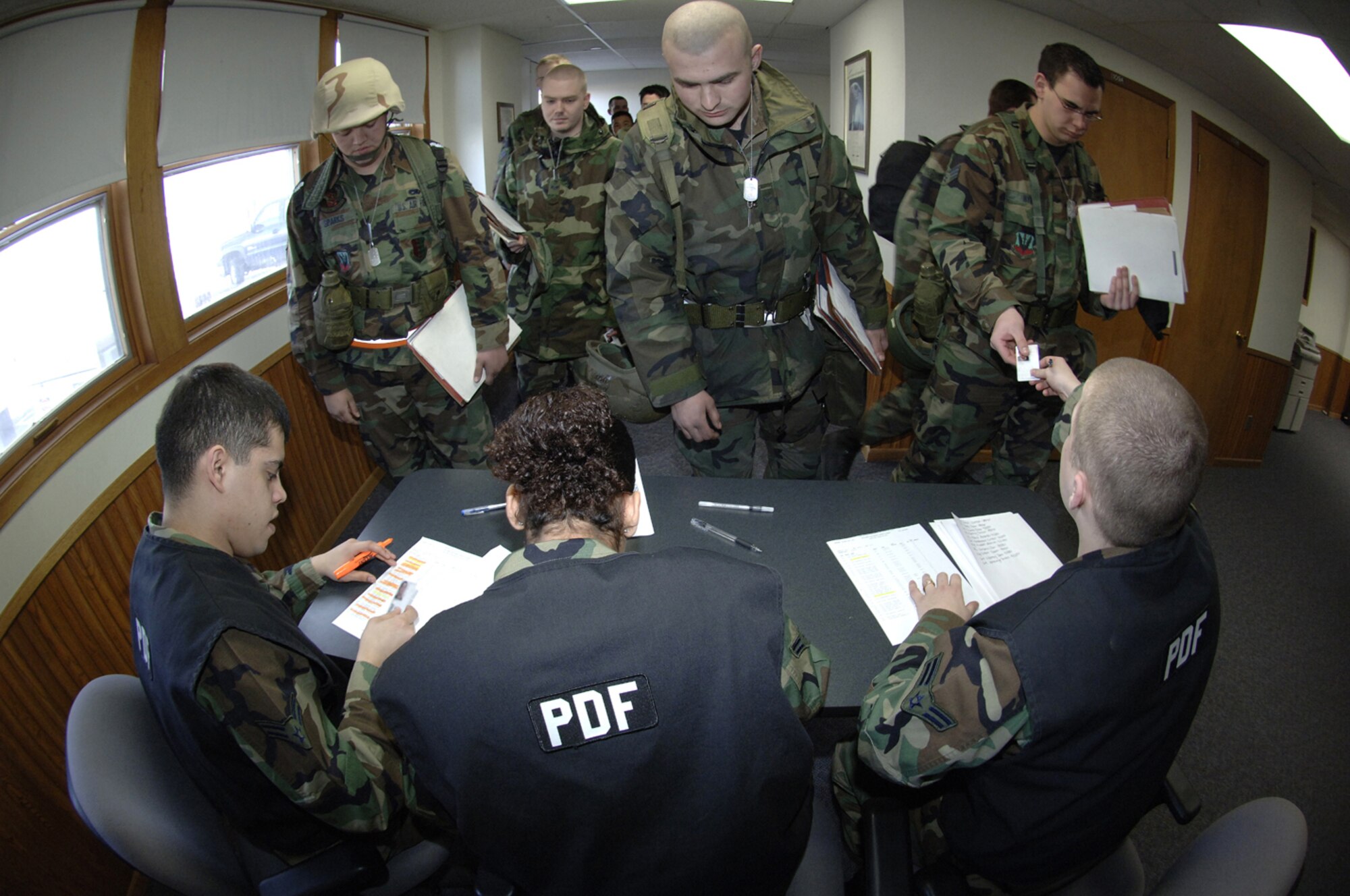 28th Bomb Wing members have their identification cards checked during a simulated deployment line at Ellsworth Air Force Base, S.D., March 5. Ellsworth is conducting an operational readiness exercise in preparation for a scheduled operational readiness inspection later this year. (U.S. Air Force photo/Staff Sgt. Michael B. Keller)