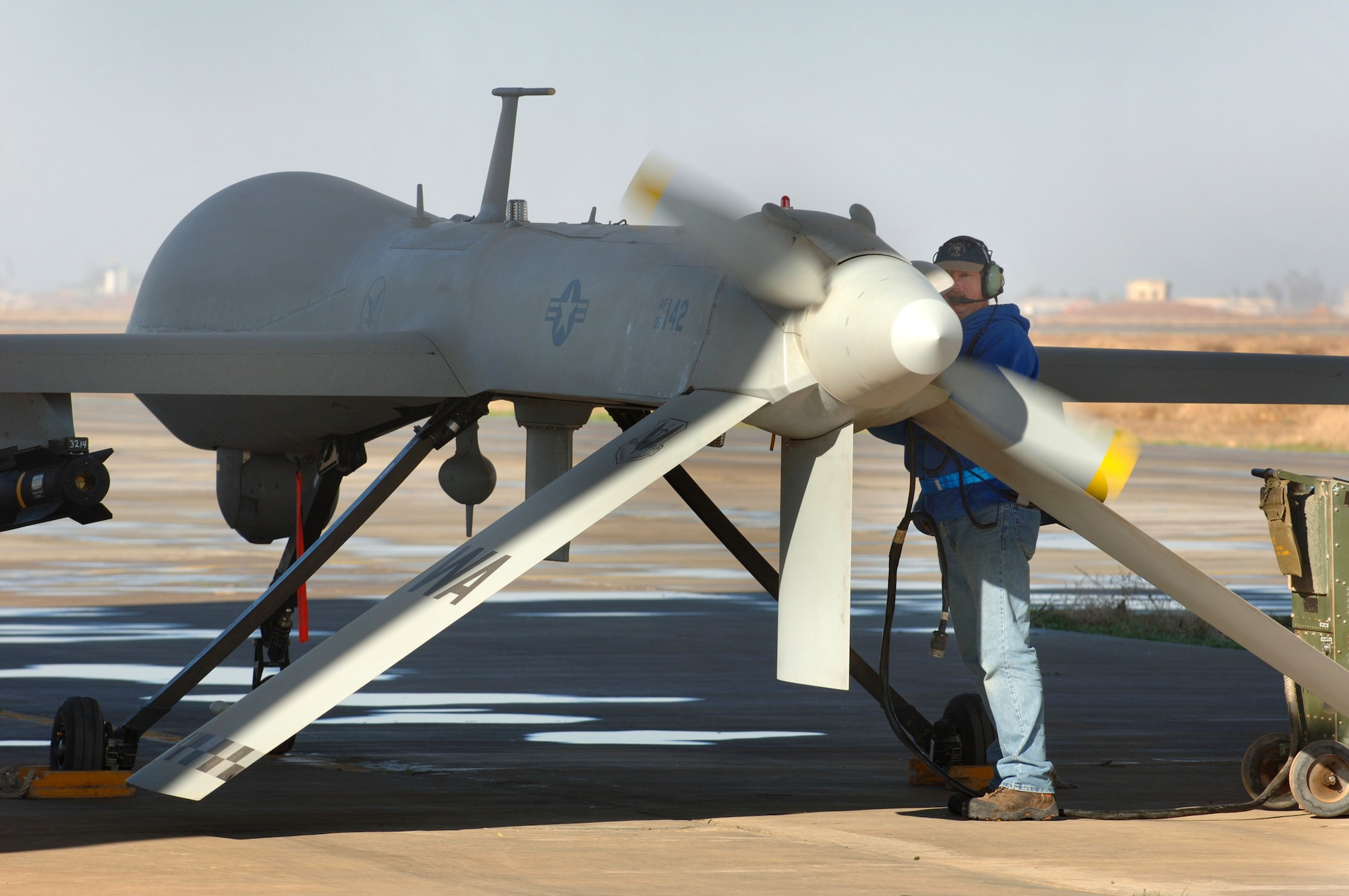 Bruce Ottenwess conducts pre-flight checks before launching the  MQ-1 Predator Unmanned Aerial Vehicle Jan. 31 from Balad Air Base, Iraq. Mr. Ottenwess is a General Atomics Aeronautical Systems Airframe and power plant mechanic based out of Creech Air Force Base, Nev. (U.S. Air Force photo/Staff Sgt. Michael R. Holzworth) 