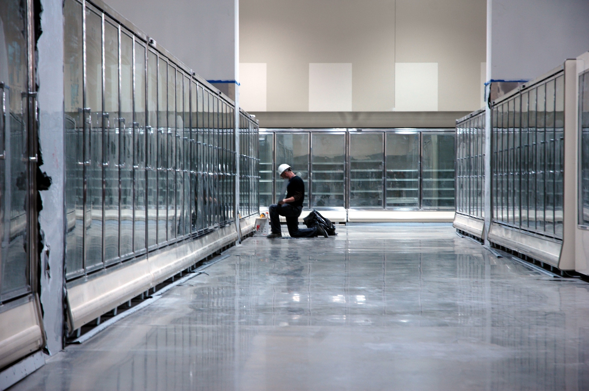 A construction worker installs freezer equipment at the commissary. The new complex occupies about 240,000 square feet, double the size of the existing commissary and PX. (U.S. Air Force photo by Steve Brady)