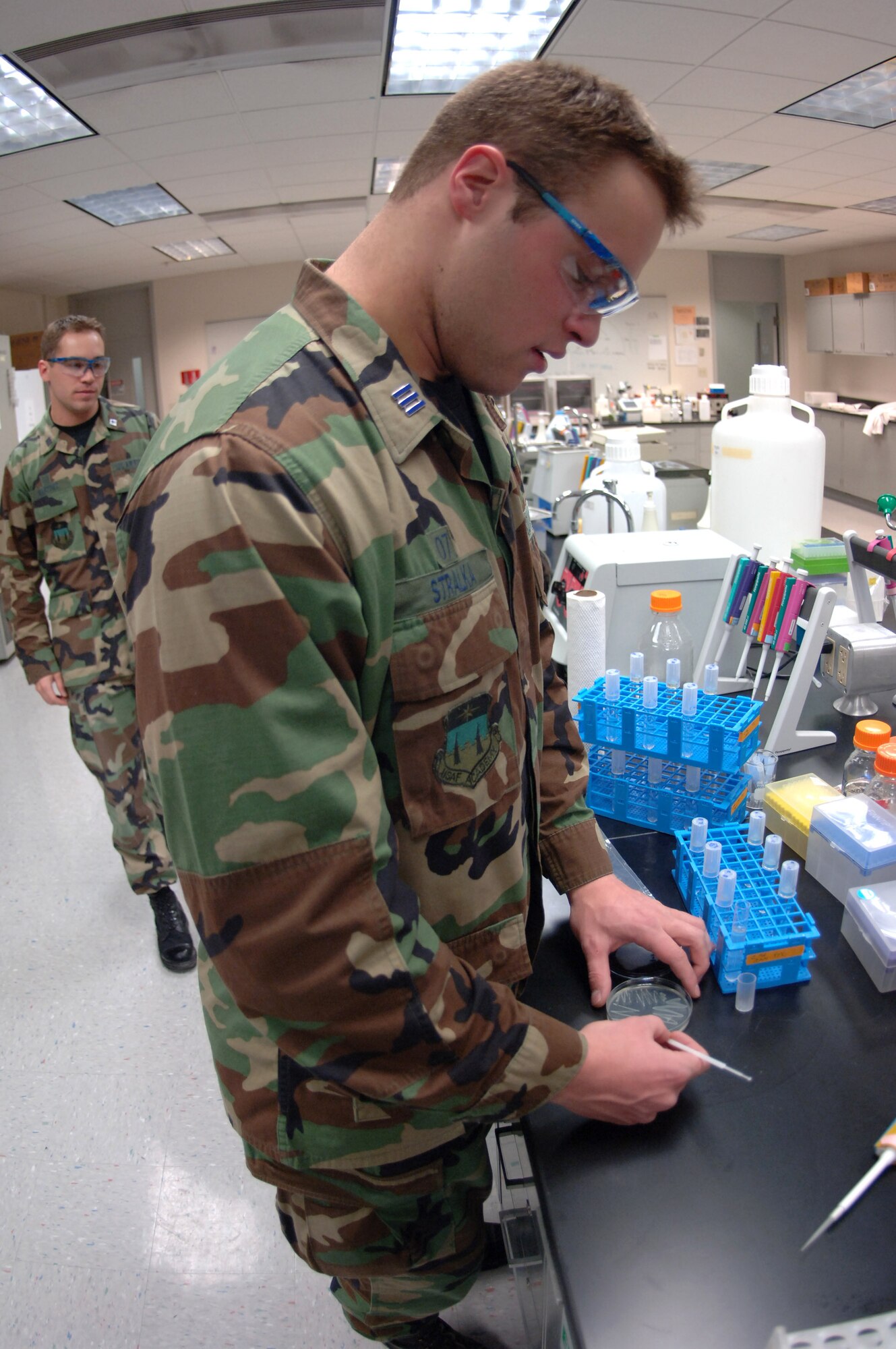 Cadet 1st Class Jonathan Stralka transfers a single bacteria colony from an agar plate in a laboratory at the U.S. Air Force Academy in Colorado Springs, Colo. The research done here by cadets has real world implications. Cadet Stalka is studying bacteria that digest jet fuel, resulting in a slimy substance that can foul an aircraft's engine.  (U.S. Air Force photo/1st Lt. John Ross) 
