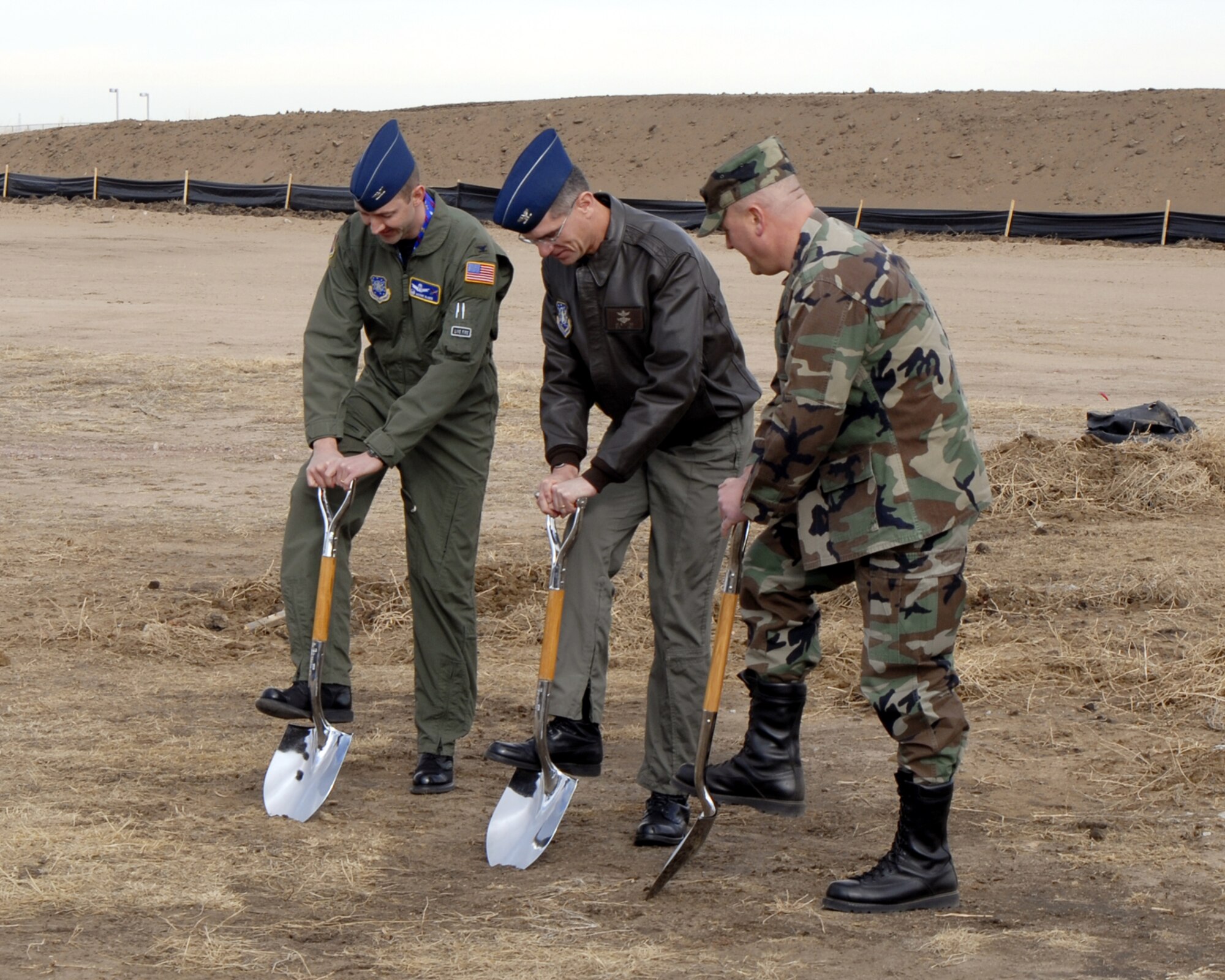 Officials broke ground Feb. 9 for the new 76th Space Control Squadron building at Pete East. Pictured are (left to right) Col. Wayne McGee, 21st Operations Group commander, Col. Jay Santee, 21st Space Wing commander, and Lt. Col. Jim Jennings, 76th SPCS commander. (U.S. Air Force photo by Allen Clutter)