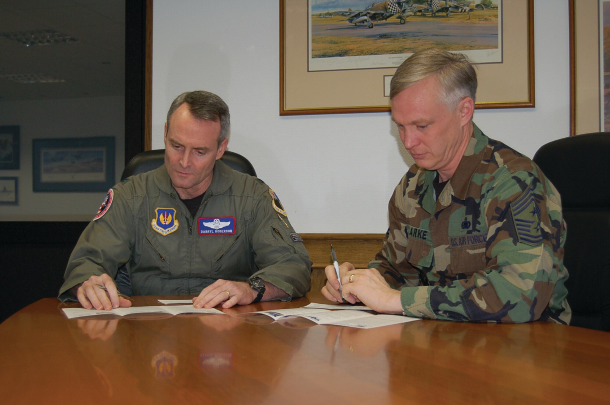 Col. Darryl Roberson, 52nd Fighter Wing commander, and Chief Master Sgt. Vance Clarke, 52nd FW command chief, complete their campaign forms for the AFAF Monday. Deductions for AFAF allotments begin June 1 and end May 31. For more information about the Air Force Assistance Fund, contact a unit representative. (US Air Force photo/Staff Sgt. Tammie Moore).