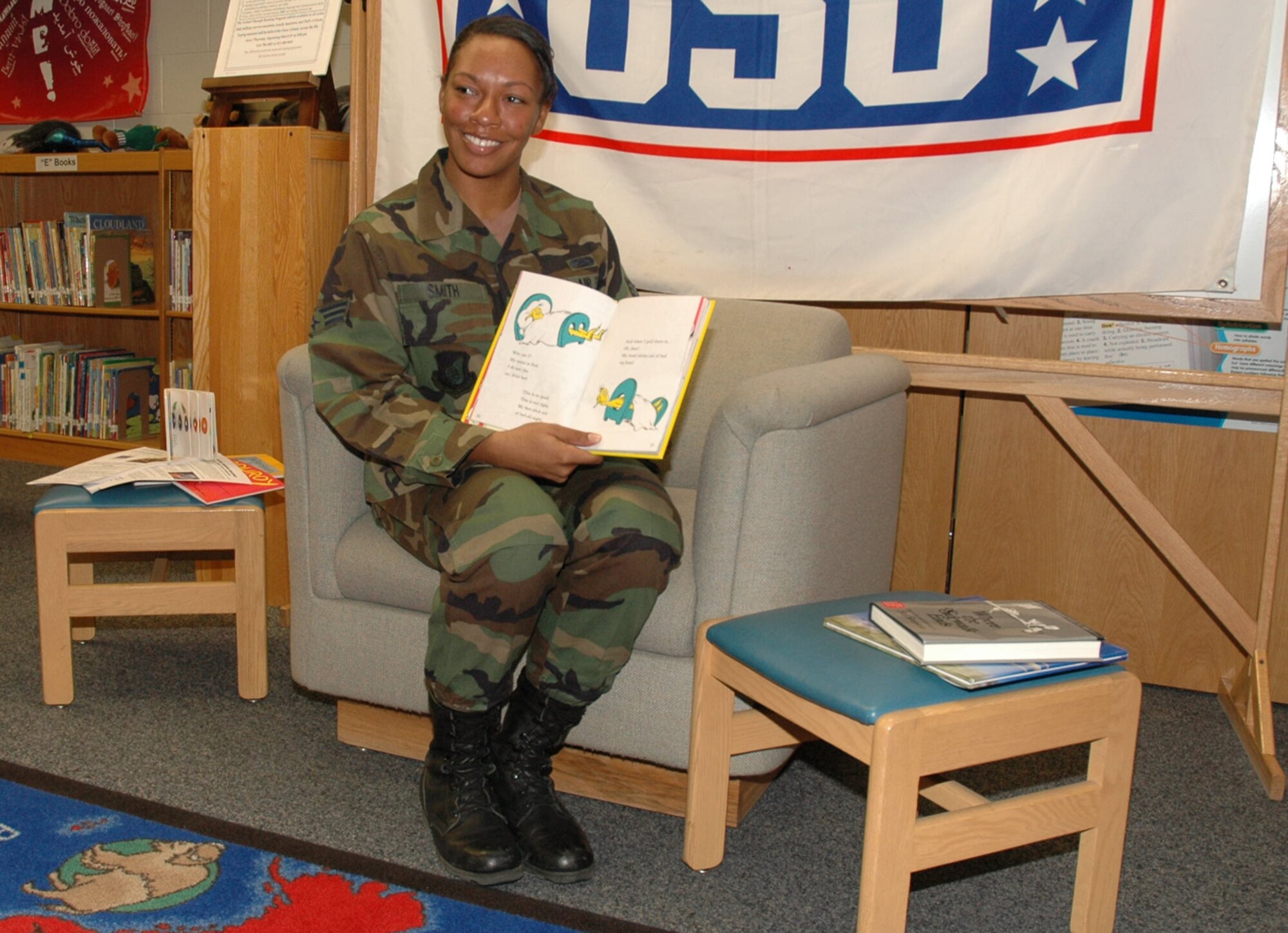 OSAN AIR BASE, Republic of Korea --  Senior Airman Amayou Smith reads "One Fish, Two Fish, Red Fish, Blue Fish" into the camera as part of the "United Through Reading" program here. United Through Reading is a Family Literacy Foundation and United Services Organization program that allows servicmembers at remote locations to read to their children or young family members on video. Airman Smith is with the 51st Communications Squadron. (U.S. Air Force photo by Staff Sgt. Benjamin Rojek)
