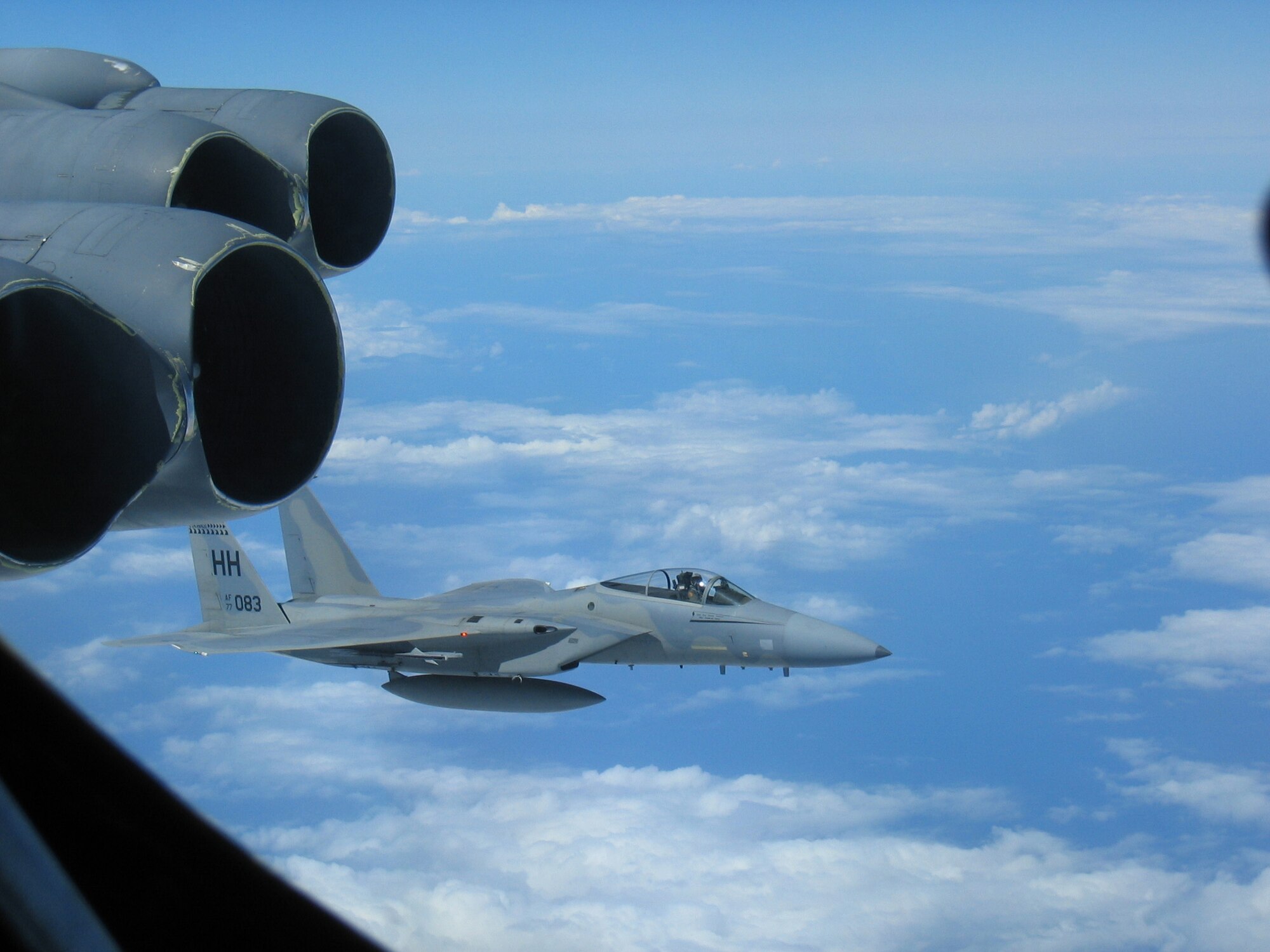 A Hickam-based F-15 flies alongside a B-52 Stratofortress deployed from Andersen Air Force Base, Guam March 2 during the recent Koa Lightning exercise held in the Pacific Theatre. Airmen from the 96th Expeditionary Bomb Squadron flew 18-hour missions in their B-52s allowing the aircrews to hone their skills in close air support and dissimilar aircraft combat training. (U.S. Air Force photo/Maj. Eric Sikes)