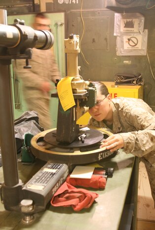 AL TAQADDUM, Iraq (March 7, 2007) ? Lance Cpl. Carla S. Winn, an optics technician with the optics section of Electronics Maintenance Platoon, 2nd Maint. Battalion(-) Reinforced, 2nd Marine Logistics Group (Forward), checks a piece of optics equipment from a light armored vehicle to be sure it works, March 7.  ?If the gunner?s gear out there is broken, they?ll have nothing to fight with,? said the Lancaster, S.C., native.