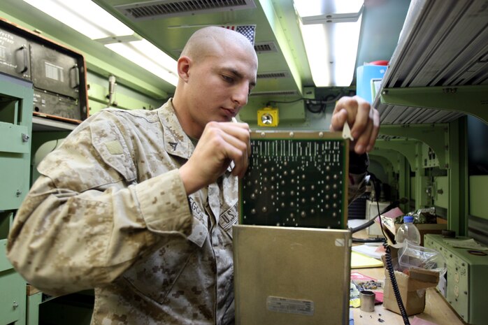 AL TAQADDUM, Iraq (March 8, 2007) ? Lance Cpl. Michael Gallegos, a tank mechanic with optics section, Electronics Maintenance Platoon, 2nd Maint. Battalion (-) Reinforced, 2nd Marine Logistics Group (Forward), checks the testing equipment in the optics shop, March 8.