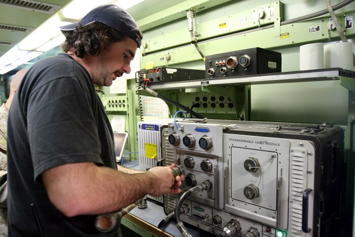 AL TAQADDUM, Iraq (March 8, 2007) ? David Lang, an instruments control senior repair technician with Lear Siegler Inc., checks optics equipment in the optics shop, March 8.  Lang, a Buffalo, N.Y., native, is currently attached to the optics section of Electronics Maintenance Platoon, 2nd Maint. Battalion (-) Reinforced, 2nd Marine Logistics Group (Forward).