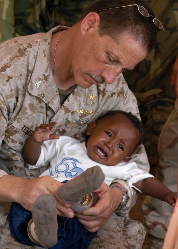BARGONI, KENYA (March 7, 2007) Capt. Steve Temerlin examines a child’s leg during a Medical Civil Assistance Project (MEDCAP) at Barigoni School as part of the bilateral exercise Edged Mallet ‘07. Edged Mallet is a U.S. and Kenyan military exercise designed to enhance interoperability and tactical proficiency of Kenyan and U.S. Forces, while providing practical training for medical specialists. U.S. Navy photo by Mass Communication Specialist 2nd Class (AW) Jeremy L. Grisham (RELEASED)