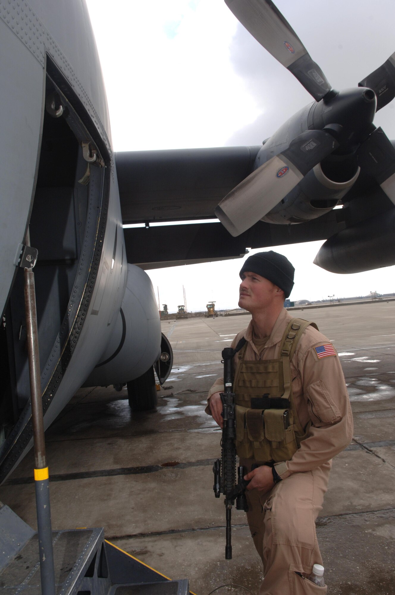 Senior Airman Kyle Battell of the 455th Expeditionary Security Forces Squadron prepares to enter a C-130 Hercules for a fly away mission. Fly away security teams (FAST) are designed to protect aricraft in hostile environments. Airman Battell has flown over 20 of these missions. (U.S. Air Force photo by Staff Sgt. Kevin Tomko)
