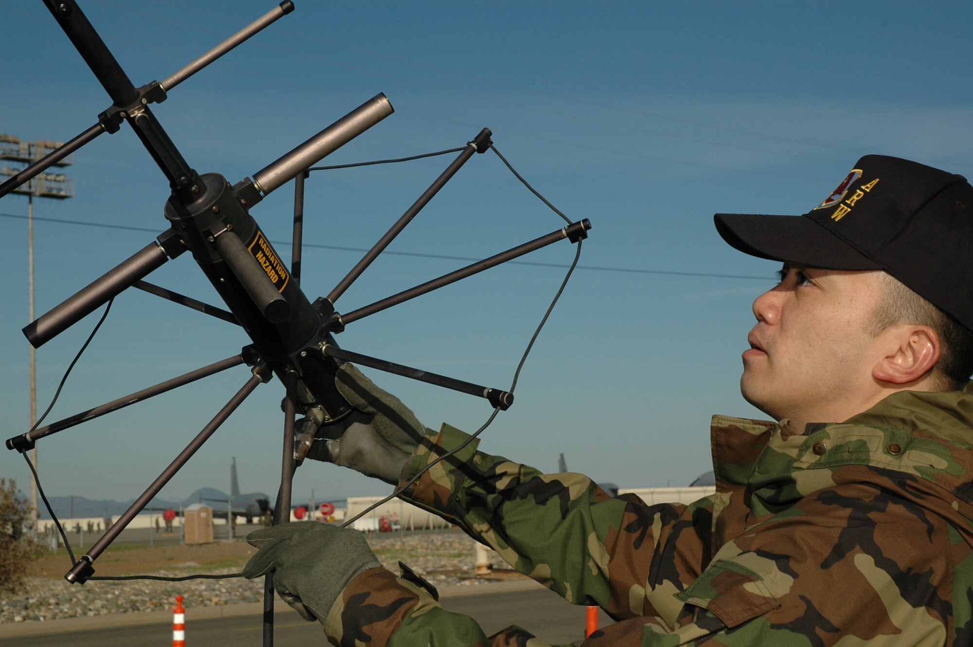 Air Force Reservist Tech. Sgt. David Salvador, 940th Communications Flight secure communications specialist, adjusts an antenna prior to establishing a satellite communication link during training March 3, 2007 at Beale Air Force Base, Calif.  The satellite radio equipment provides both secure and unsecure voice and data capability. (U.S. Air Force photo/Stacey Knott)  
