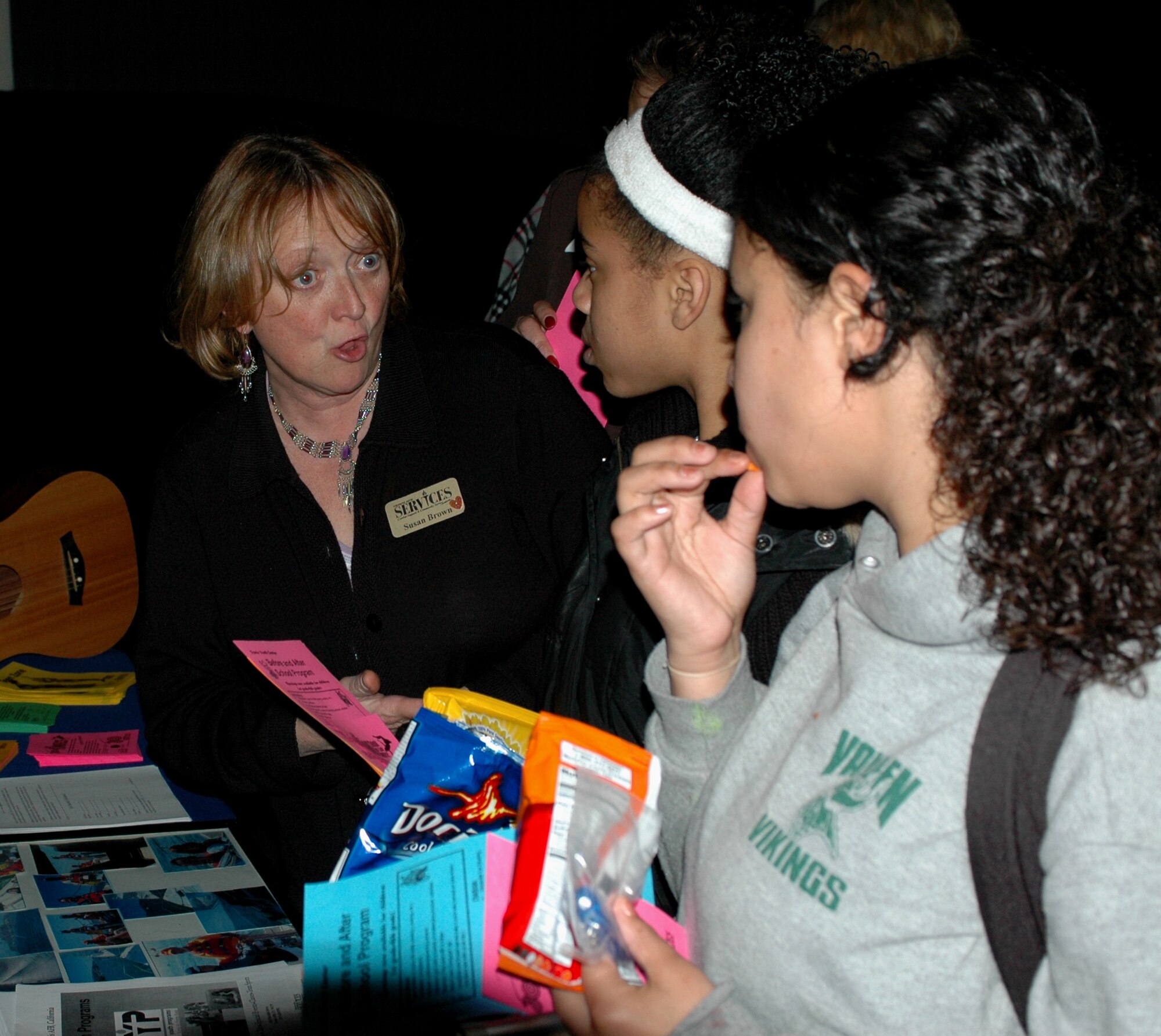 Ms. Susan Brown, 60th Services Squadron Teen Center coordinator, tells Geneva Miller, (center), 13, and Rica Young, (right), 13, about events and services offered by the Teen Zone during the Town Hall meeting March 1. Geneva is the daughter of Master Sgt. Joan Miller, 60th Communications Squadron, and Rica is the daughter of Tech. Sgt. Kenneth Kreps, 60th Maintenance Operations Squadron. During the event, Travis’ housing residents had the opportunity to learn more about Travis’ housing privatization future, base housing safety and security and also had the opportunity to ask questions to the leadership. (U.S. Air Force photo Tech. Sgt. Donald Osborn)