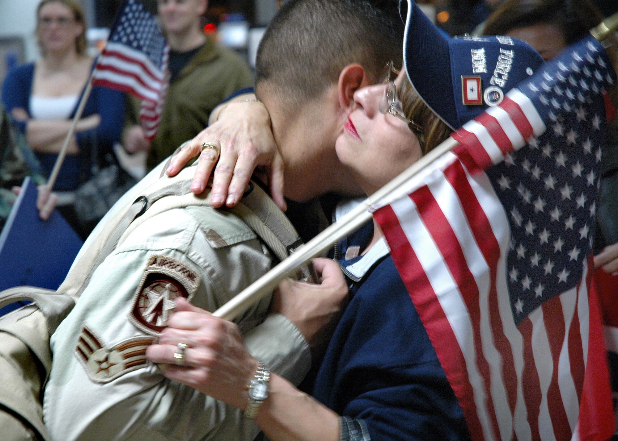 Sacramento, Calif. -- Senior Airman Michael Coughlin is hugged by his mother, Rita Coughlin, at Sacramento International Airport. Airman Coughlin was one of four Air Force Reservists from the 940th Security Forces Squadron, Beale Air Force Base, Calif., who returned home March 4, 2007 after six months' service at Camp Bucca, Iraq. (U.S. Air Force photo / Maj. Robert Couse-Baker)
