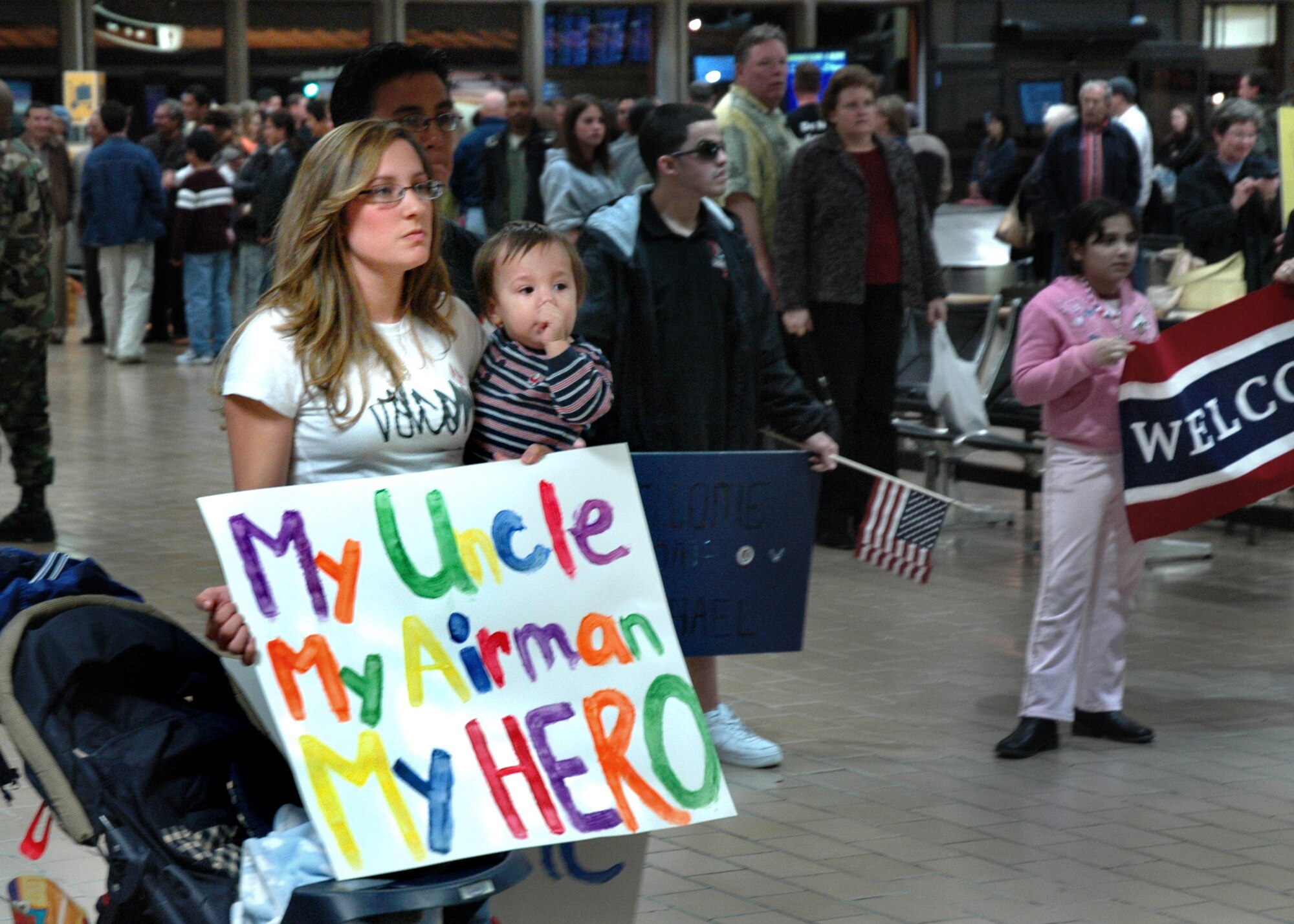 Sacramento, Calif. -- Air Force Reservist Staff Sgt. Steven Clayton's sister, Rachel Clayton, and nephew, Tegan, prepare to welcome home their personal hero at Sacramento International Airport. Sergeant Clayton was one of four Airmen from the 940th Security Forces Squadron, Beale Air Force Base, Calif., who returned home March 4, 2007 after six months' service at Camp Bucca, Iraq. (U.S. Air Force photo / Maj. Robert Couse-Baker)
