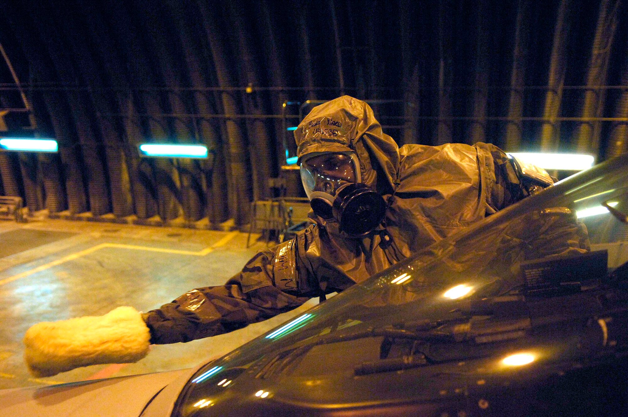 Staff Sgt Brandon Ward uses specially treated mitt March 6 to decontaminate an F-16 Fighting Falcon during a NATO Tactical Evaluation at Aviano Air Base, Italy.  The evaluation is to determine if Aviano's 31st Fighter Wing is prepared to support NATO Response Force 9/10.  (U.S. Air Force photo/Airman 1st Class Michael S. Dorus)