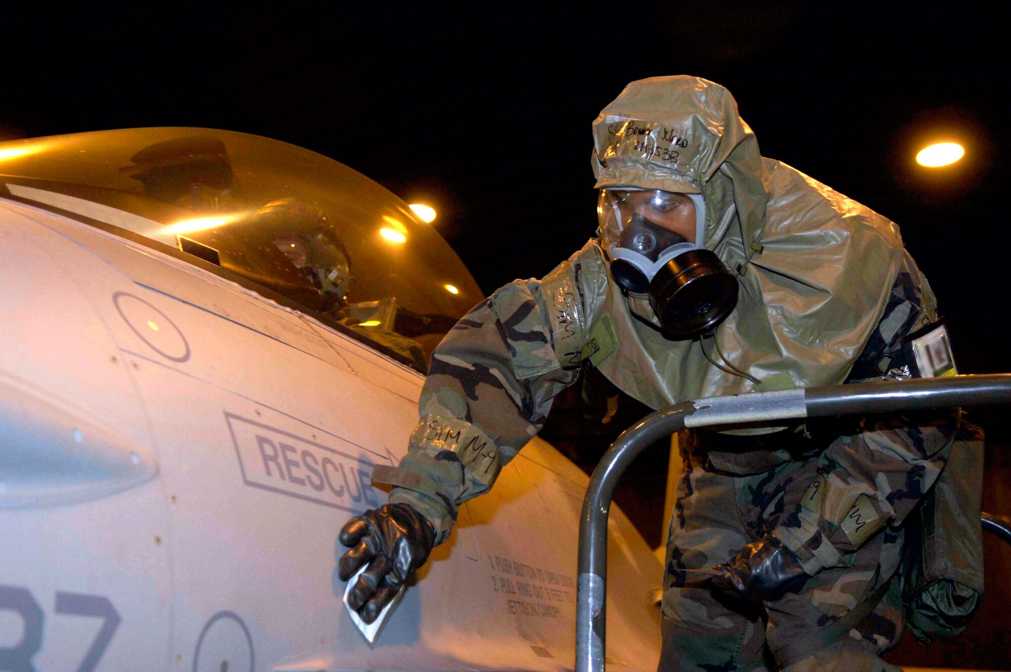 Staff Sgt Brandon Ward uses specially treated paper March 6 to detect chemical agents on an F-16 Fighting Falcon during a NATO Tactical Evaluation at Aviano Air Base, Italy.  The evaluation is to determine if Aviano's 31st Fighter Wing is prepared to support NATO Response Force 9/10.  (U.S. Air Force photo/Airman 1st Class Michael S. Dorus)