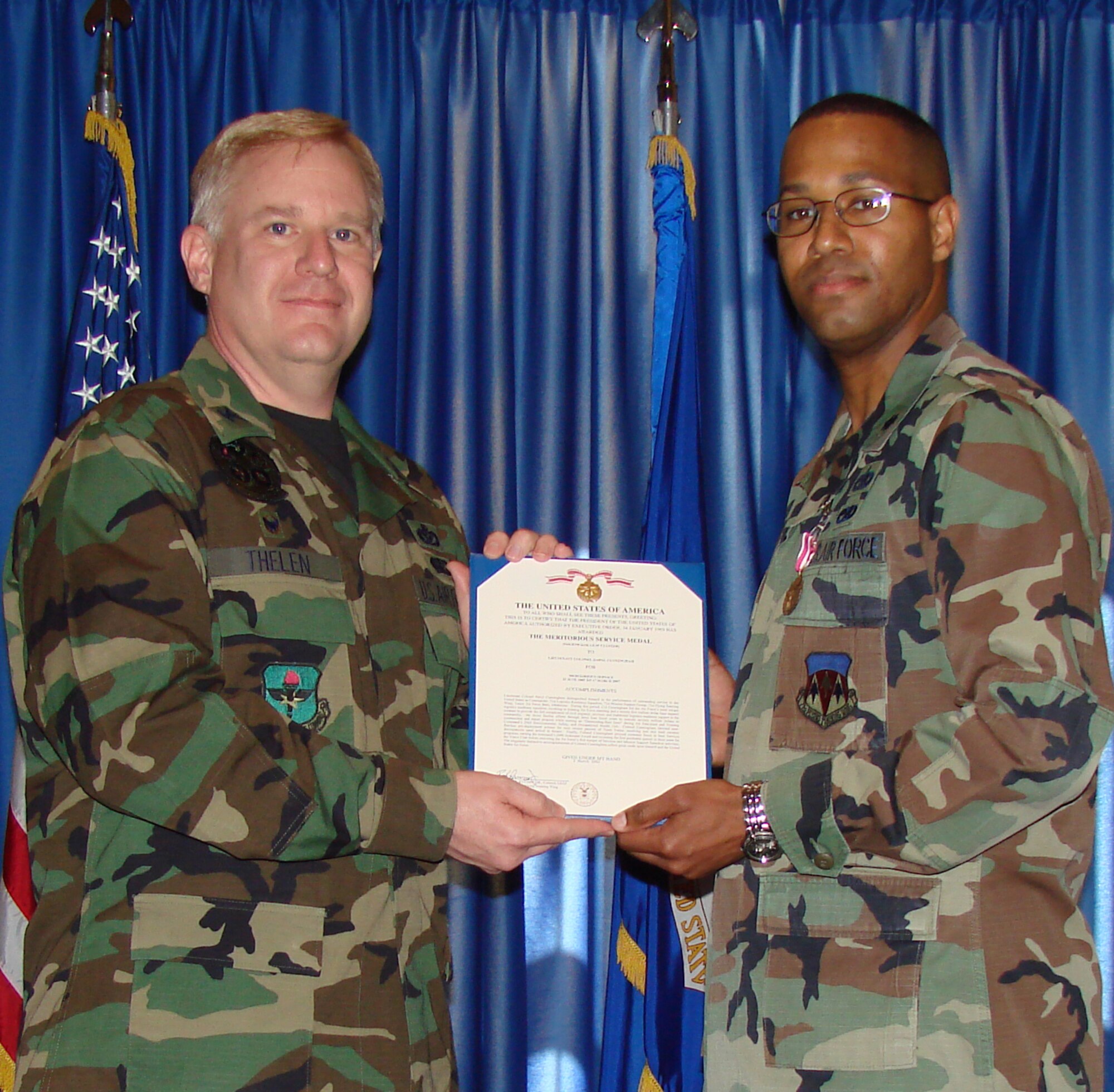 Col. Chris Thelen (left) awarded Lt. Col. Daryl Cunningham (right) the meritorious service medal as Col. Cunningham relinquished command of the 71st Logistics Readiness Squadron. Col. Cunningham will return from his deployment to assume the position of 71st Mission Support Group deputy commander. (U.S. Air Force photo/2nd Lt. Agneta Murnan)