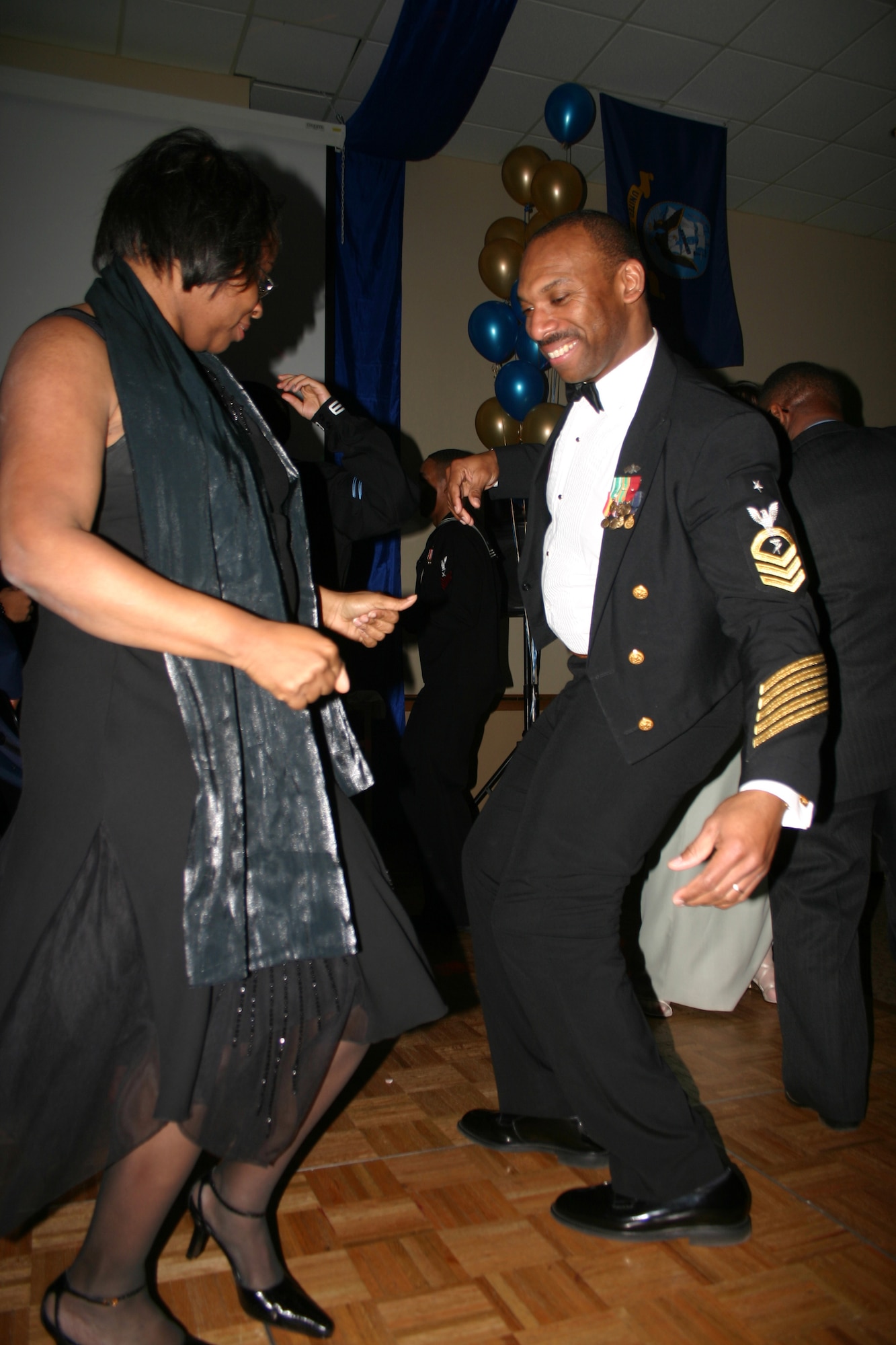 Navy Senior Chief Petty Officer Todd Bolden takes a spin on the dance floor with his sister, Sandra Bolden, during the Seabees Ball at the Howard Johnson Plaza Hotel March 3. (U.S. Air Force photo/Staff Sgt. Tonnette Thompson)